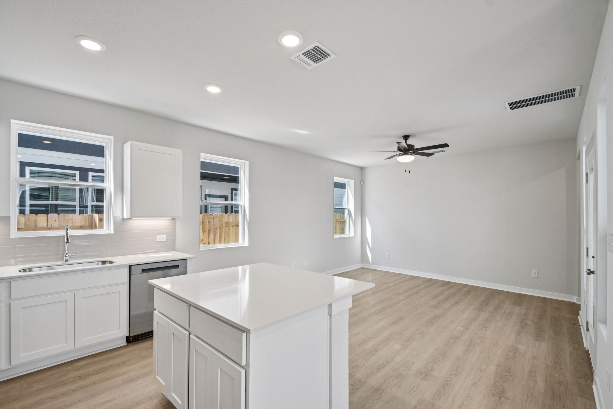 A kitchen with white cabinets.