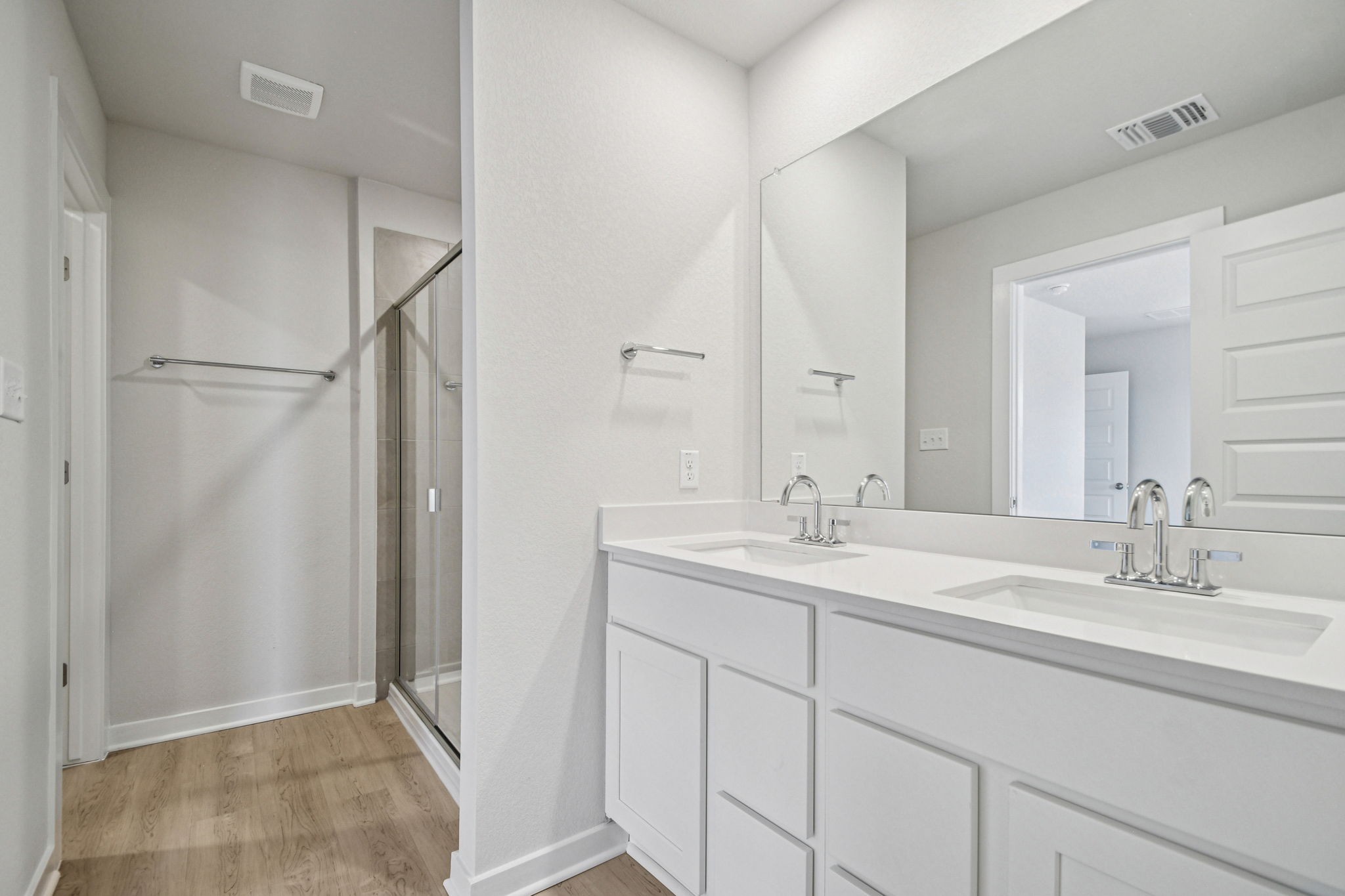 A bathroom with white cabinets.