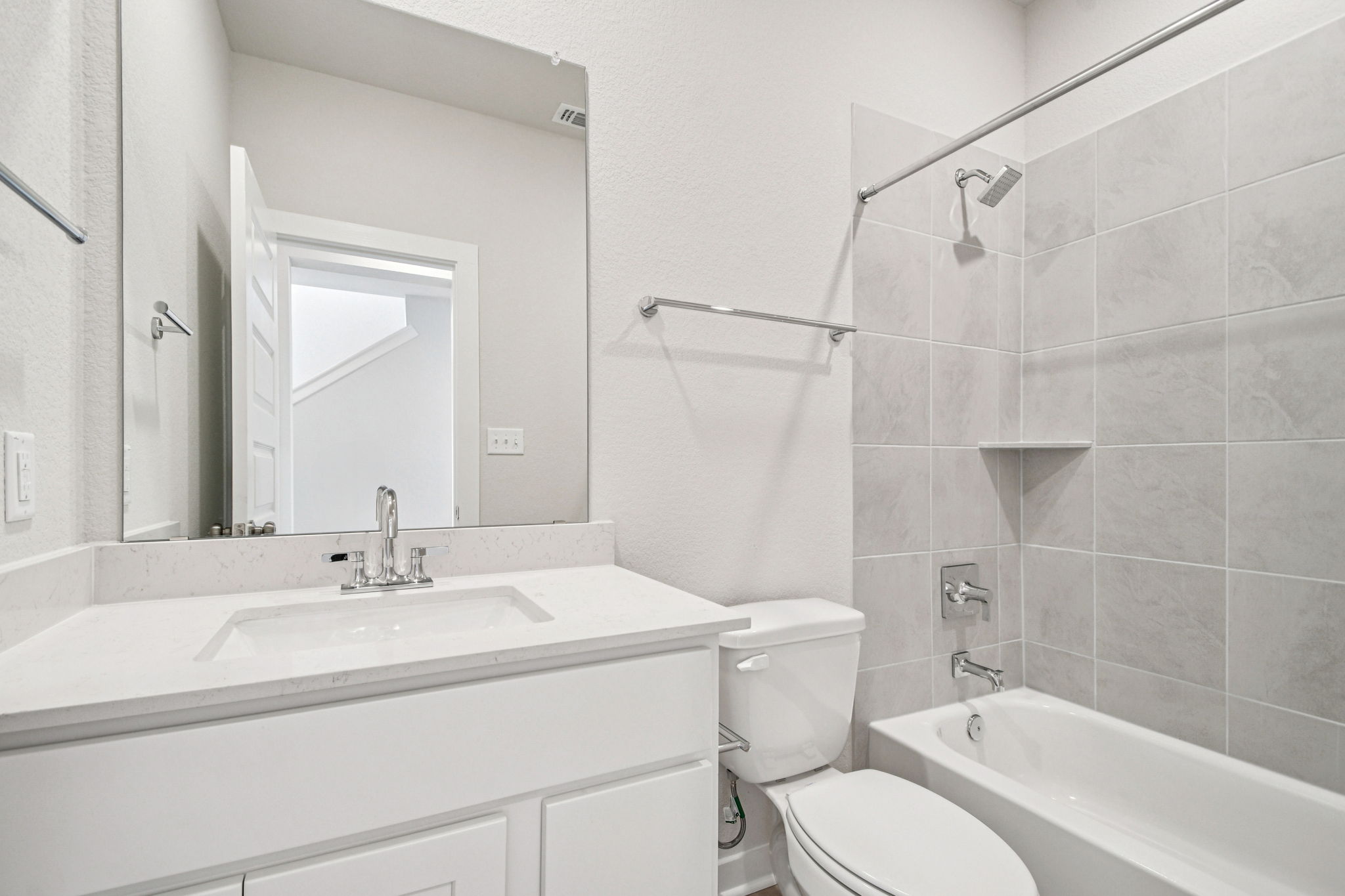 A bathroom with a sink toilet and bathtub.