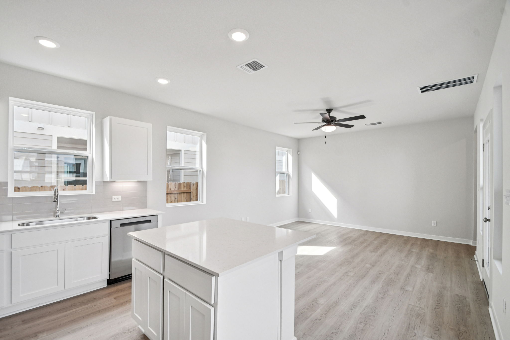 A kitchen with white cabinets.