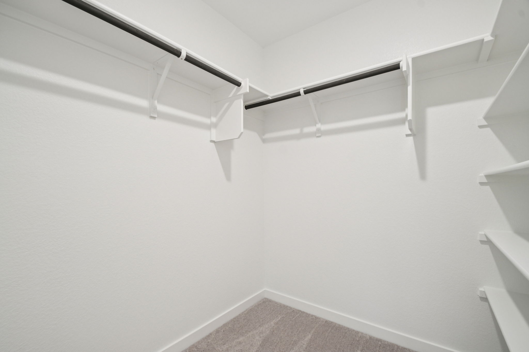 A white staircase with white walls.