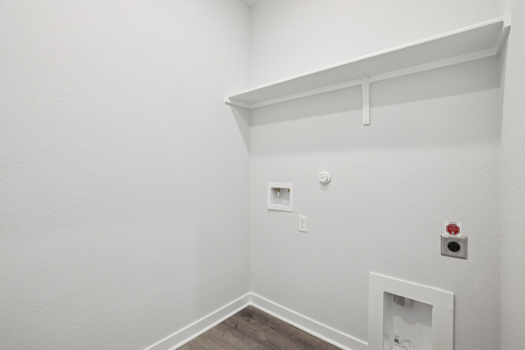 A white wall with a light fixture.