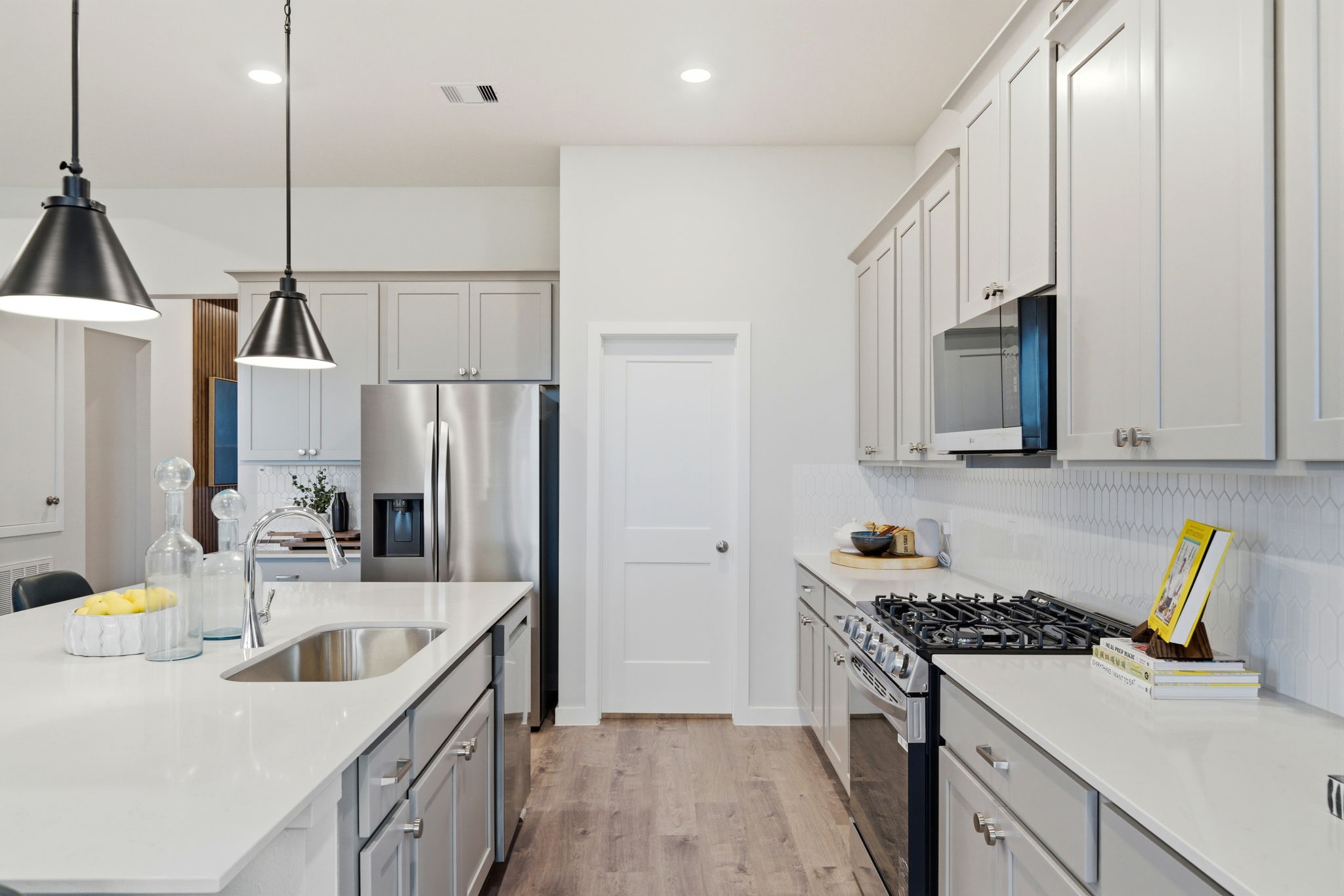A kitchen with white cabinets.
