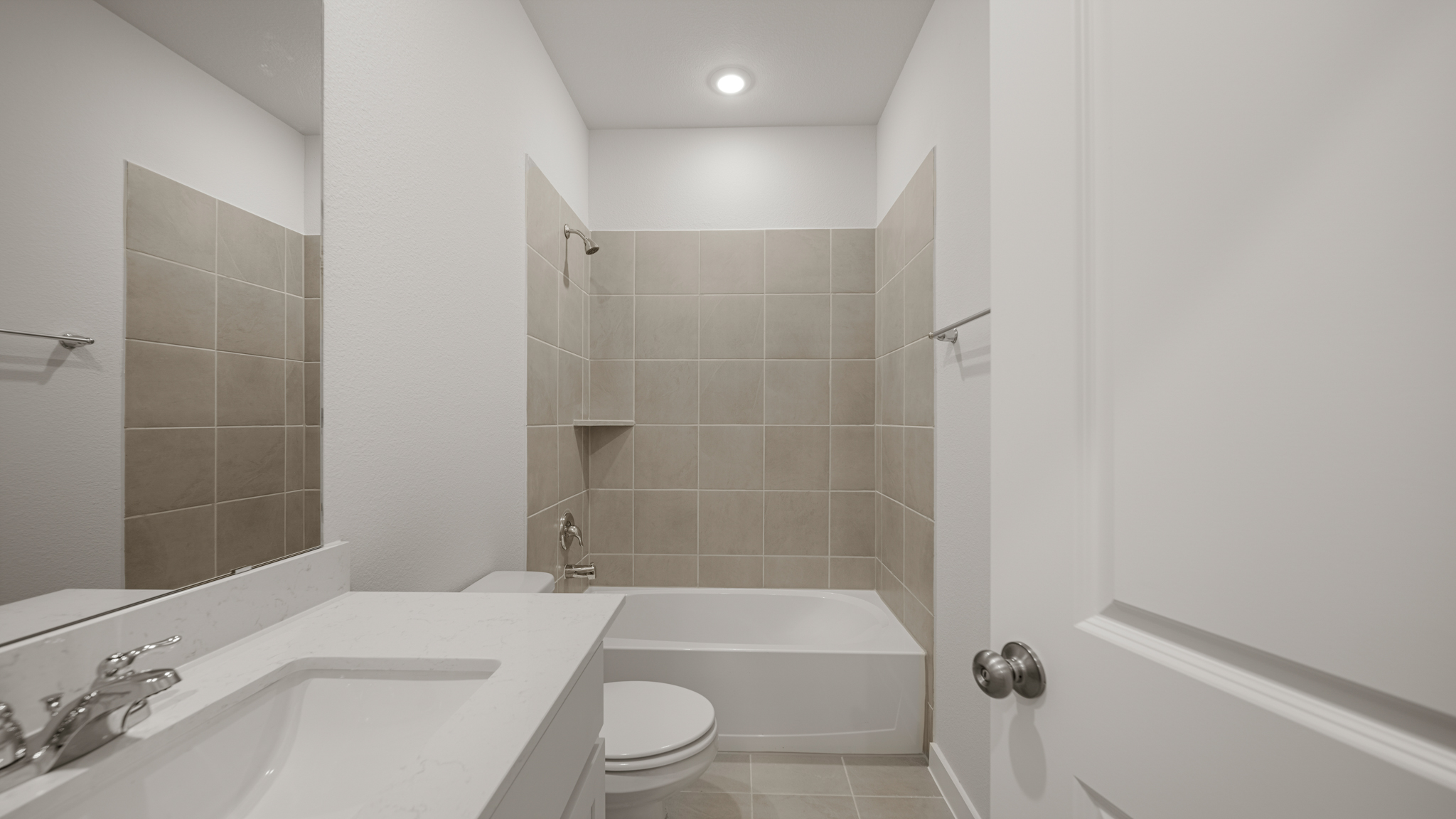 A bathroom with a tub sink and toilet.