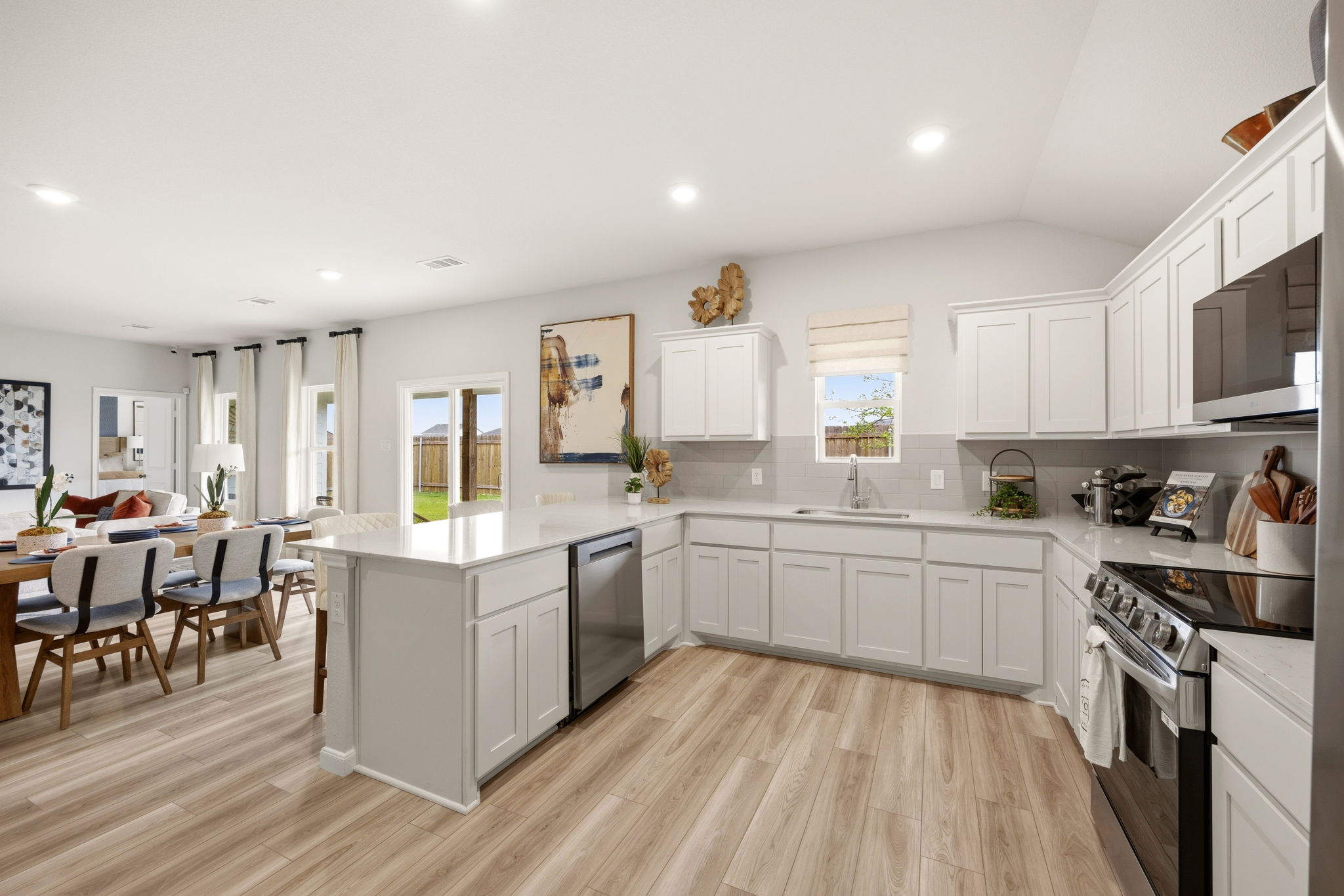 A kitchen with white cabinets.
