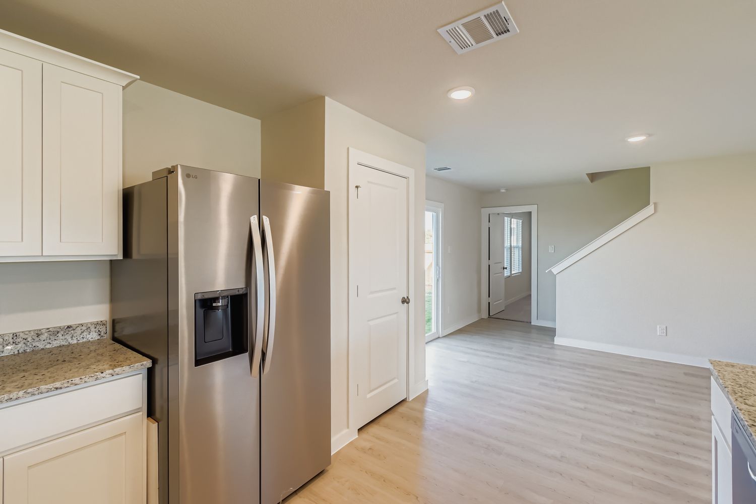 A kitchen with white cabinets.