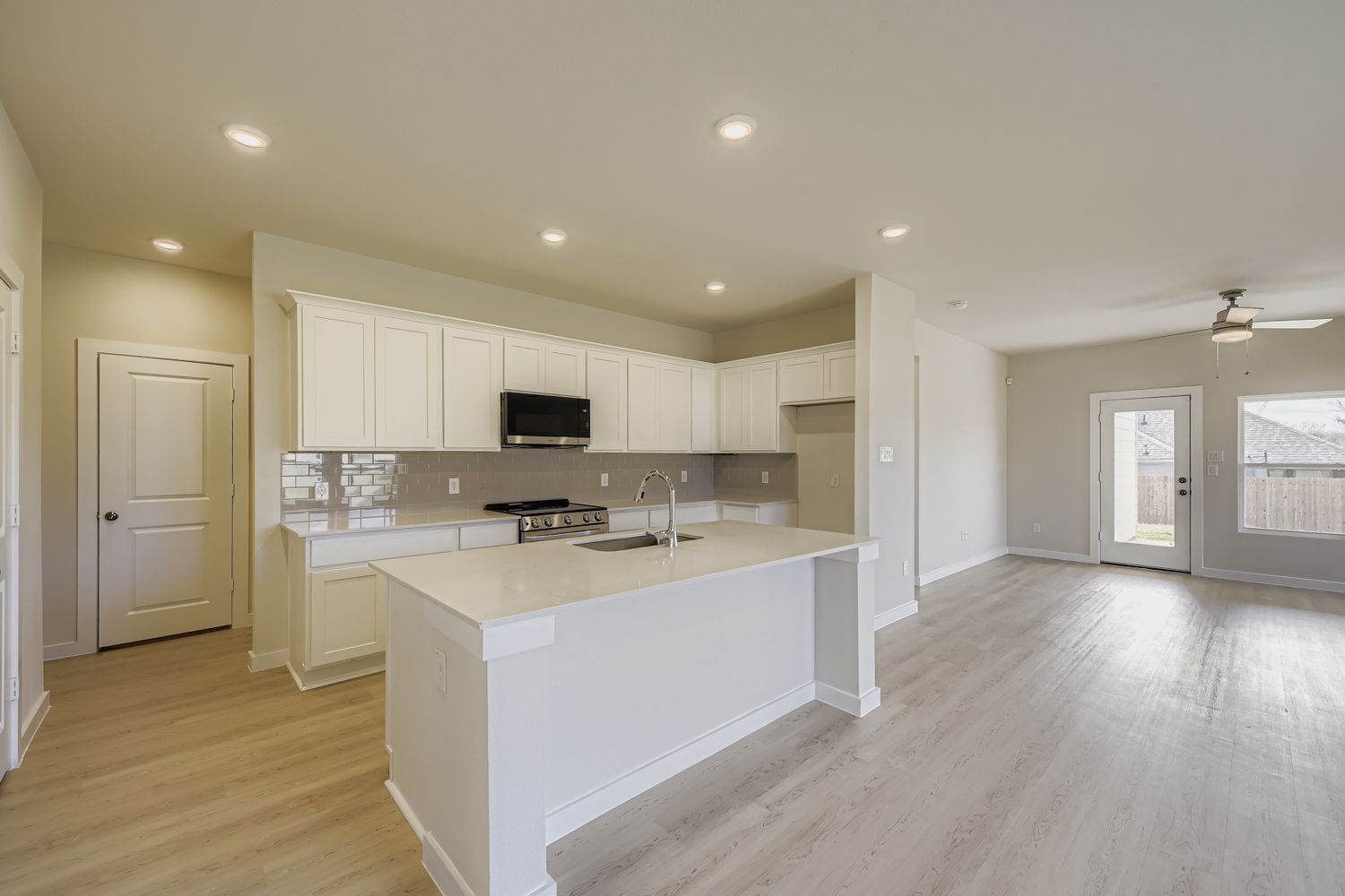 A kitchen with white cabinets.