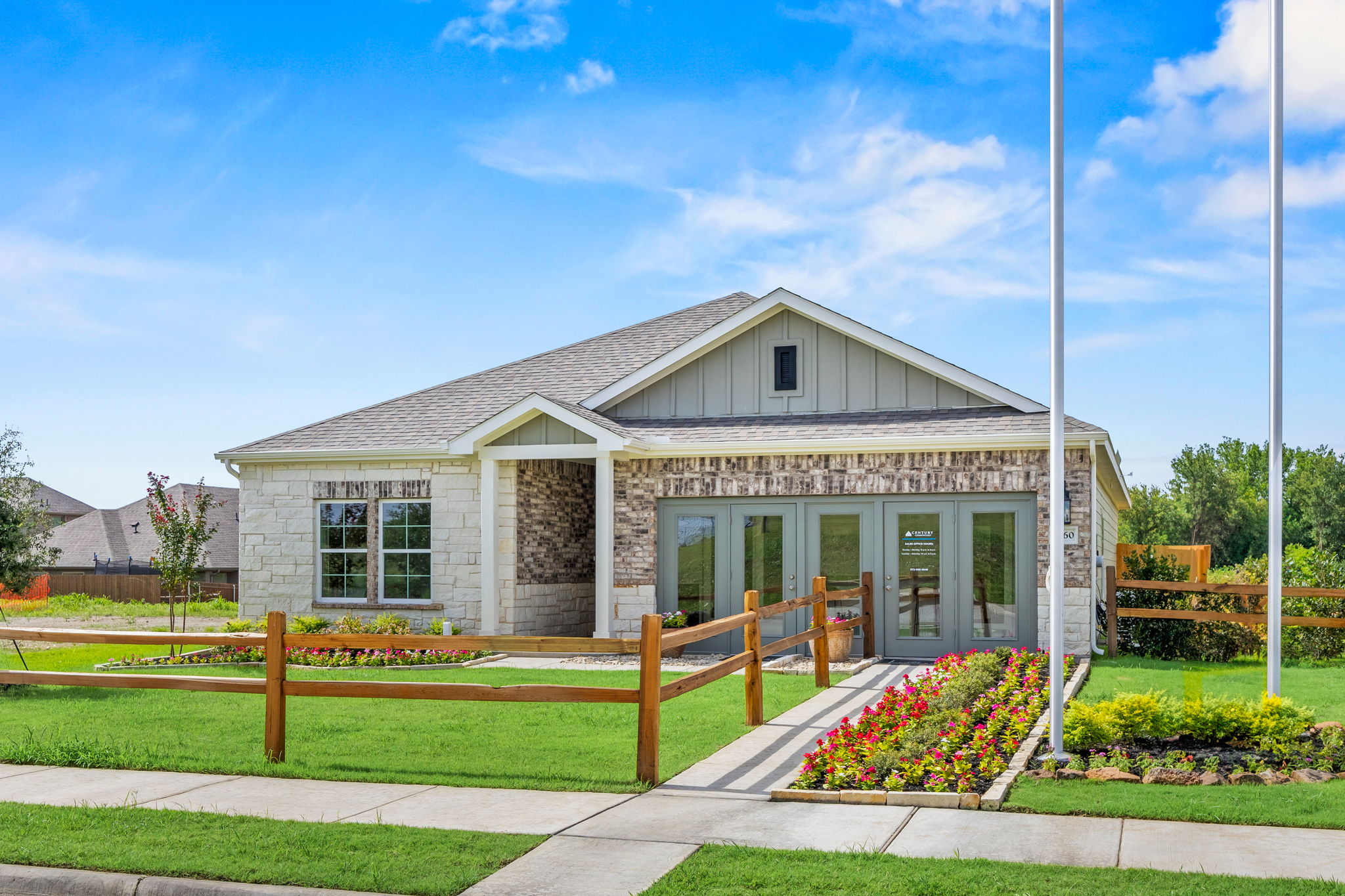 A house with a fence and a lawn in front of it with Palm Cottage in the background.