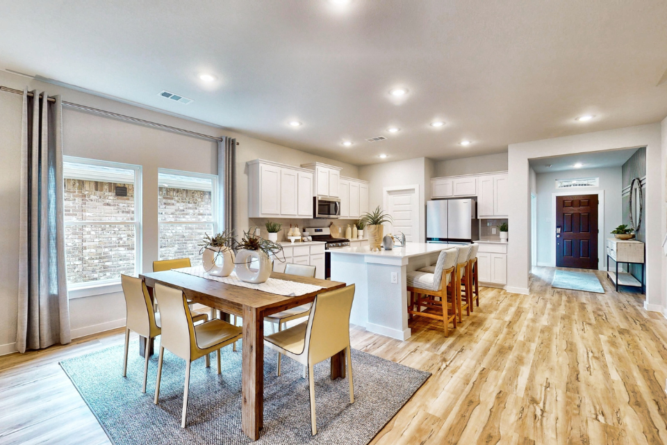 A kitchen with a dining table.