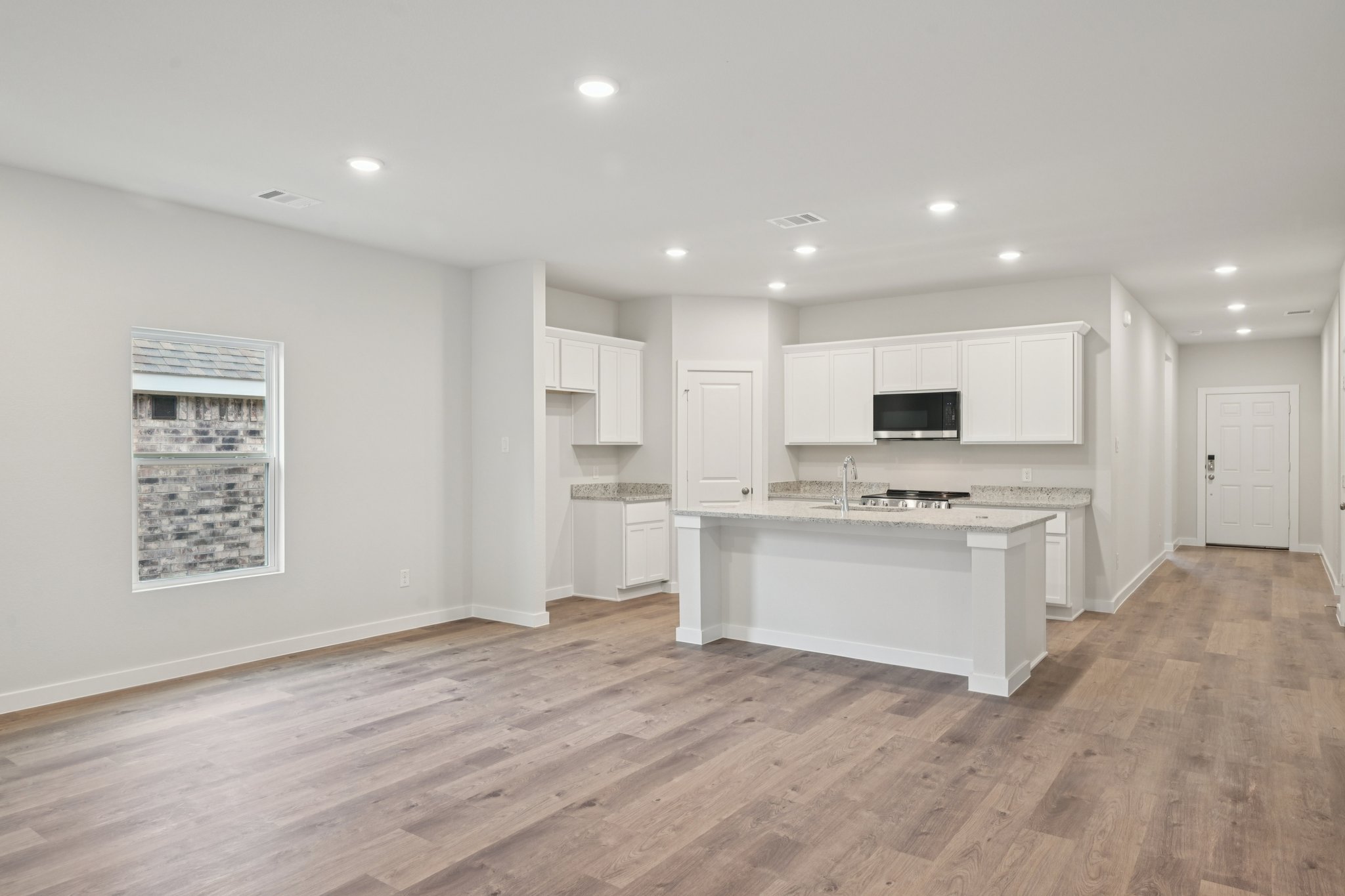 A kitchen with white cabinets.