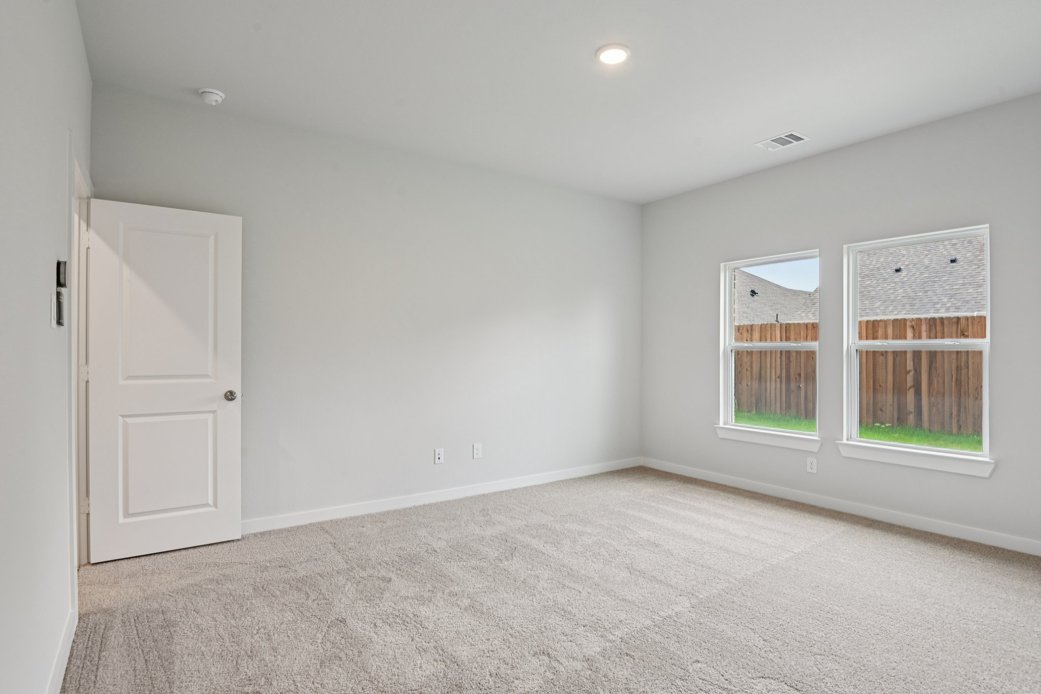 A room with a door and windows.