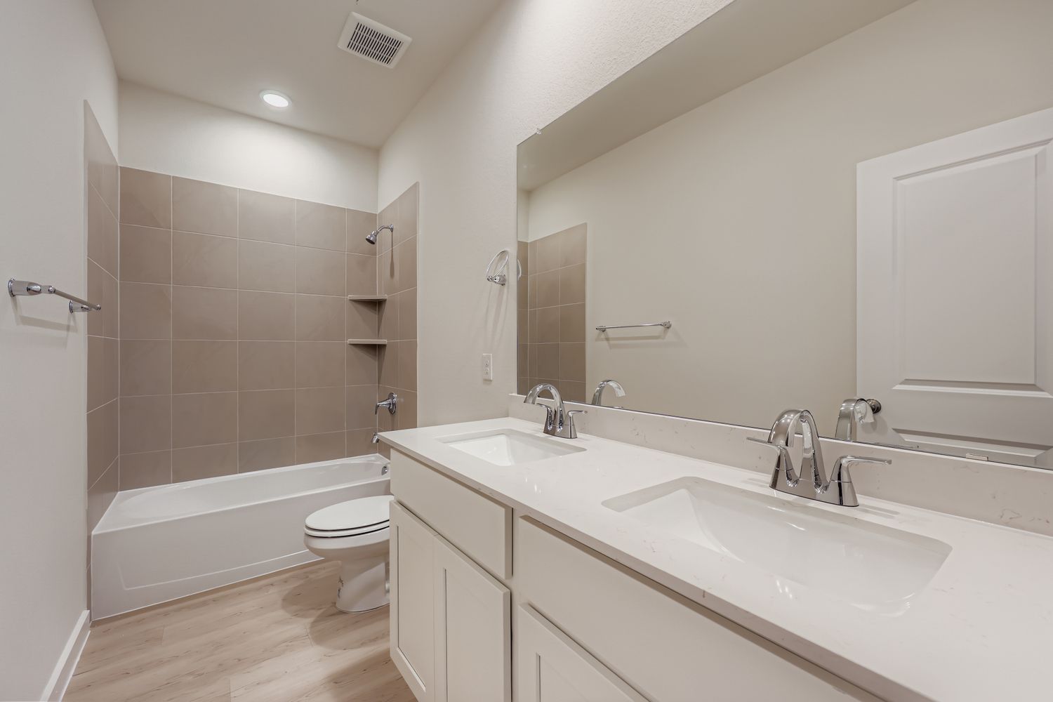 A bathroom with a tub sink and toilet.