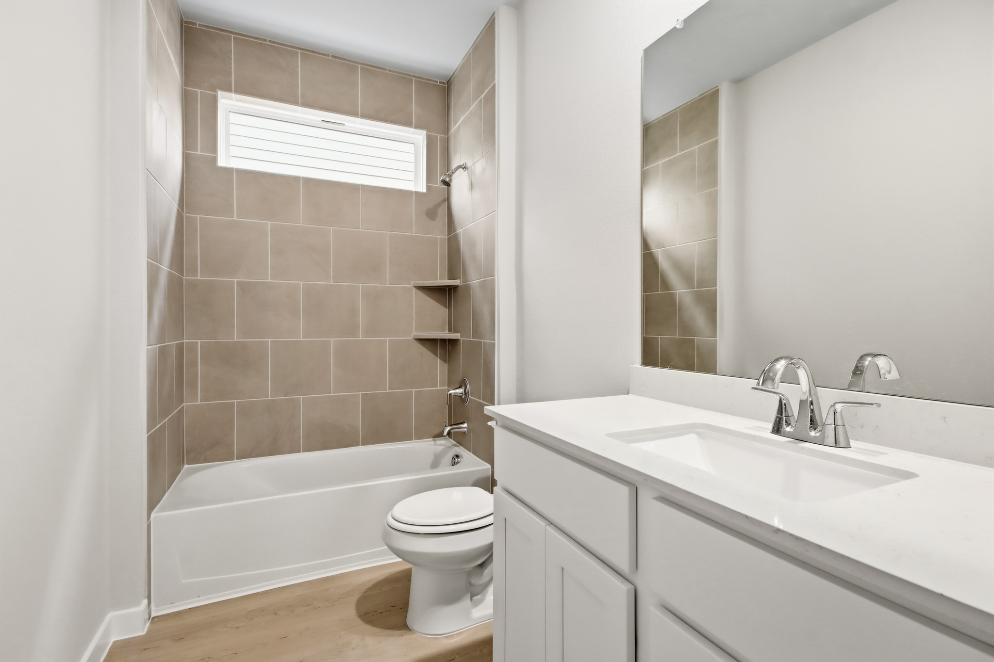 A bathroom with a tub sink and toilet.