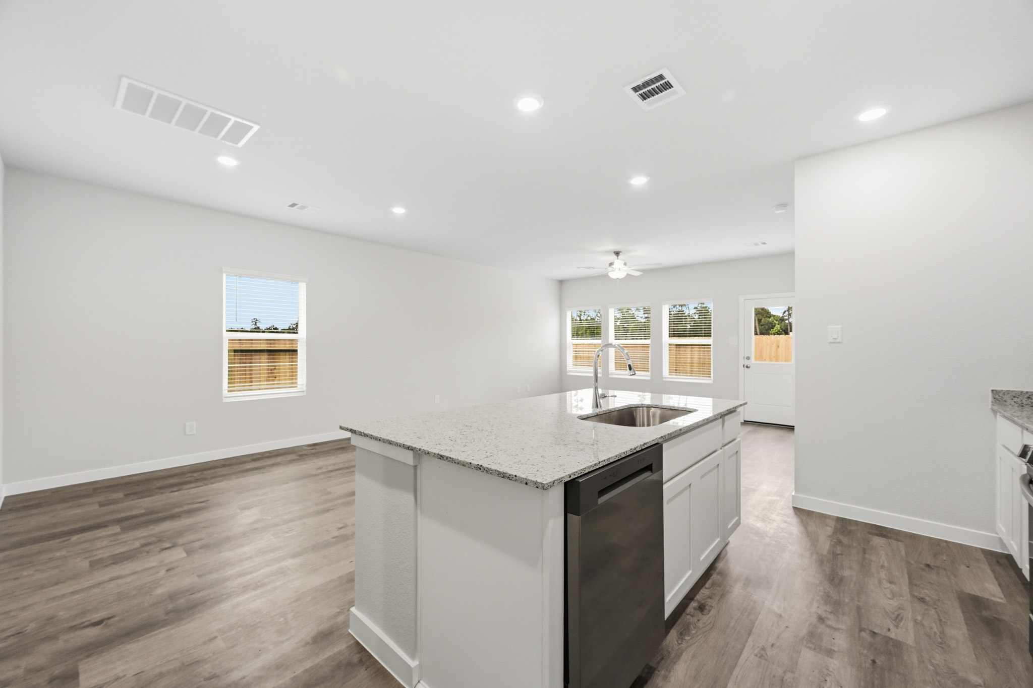 A kitchen with a marble counter top.