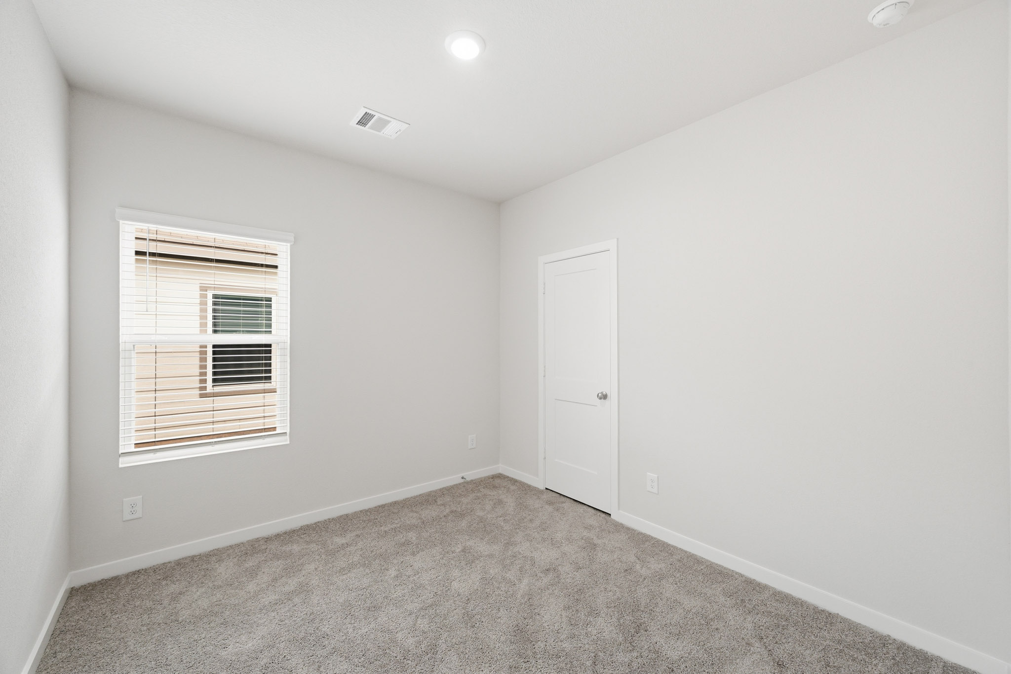 A room with a door and a window.