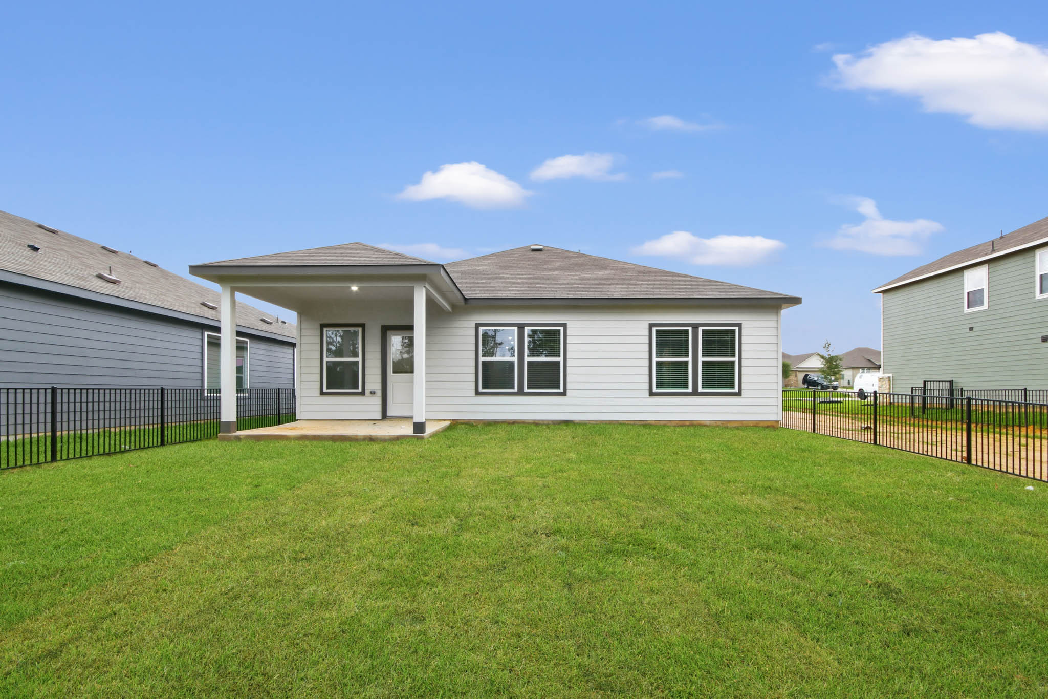 A house with a fence and grass.