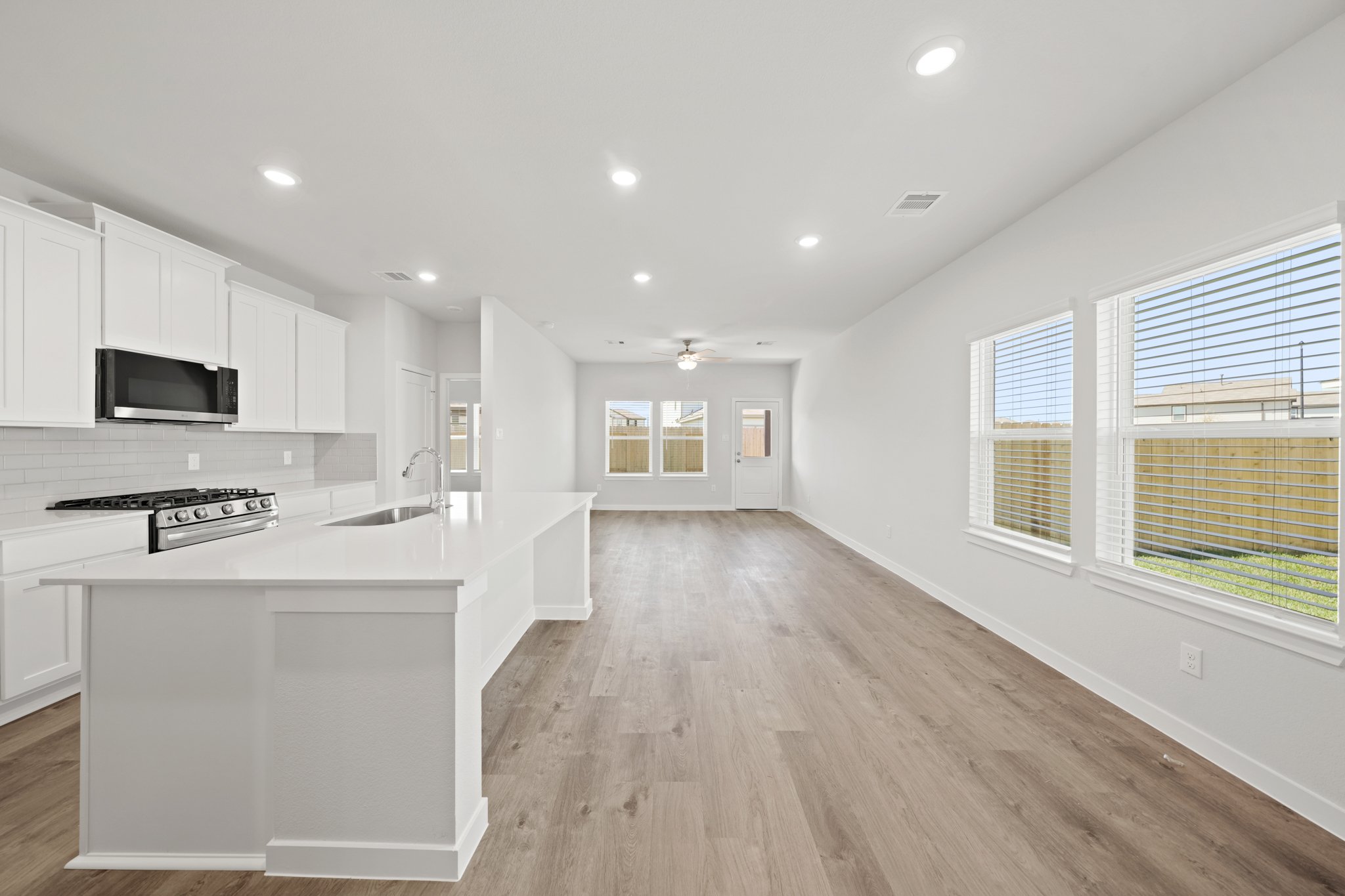 A kitchen with white cabinets.