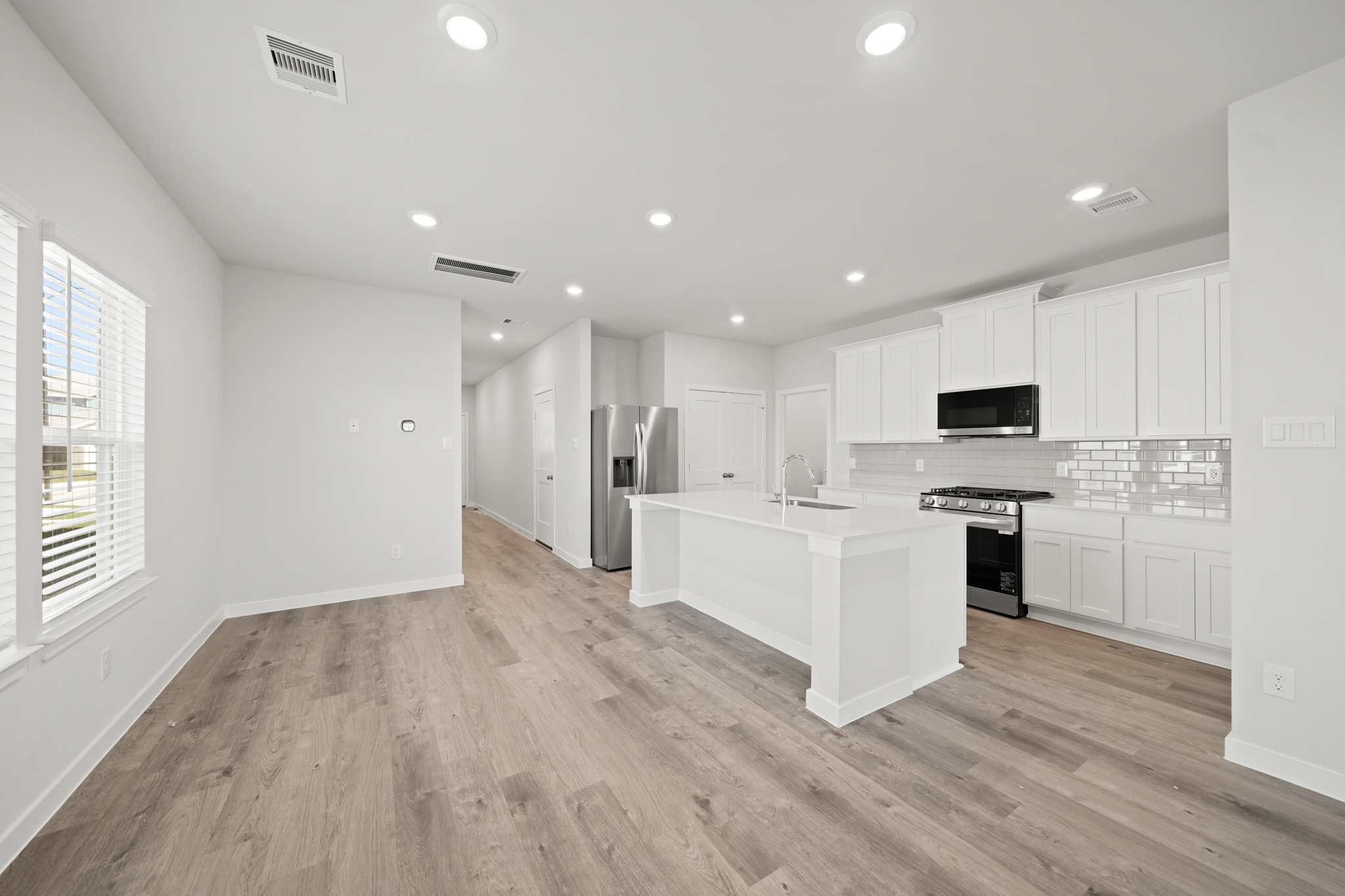 A kitchen with white cabinets.