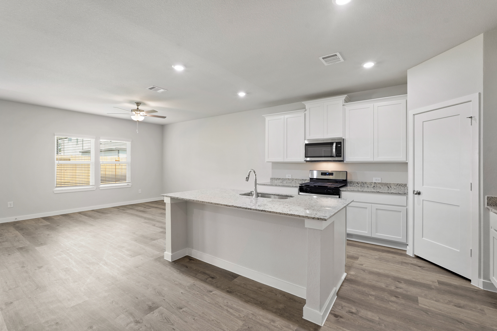 A kitchen with white cabinets.