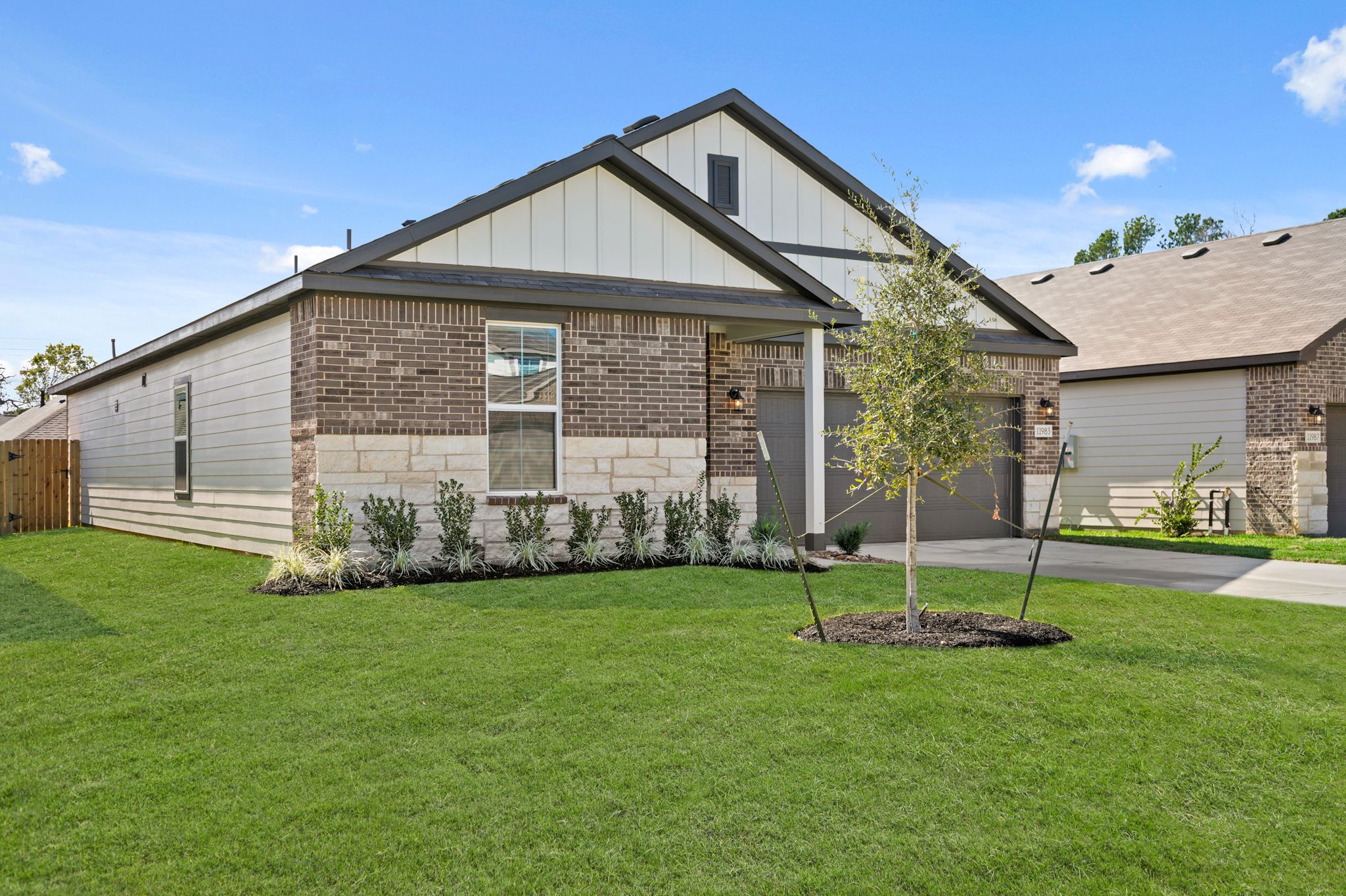 A house with a tree in the front yard.