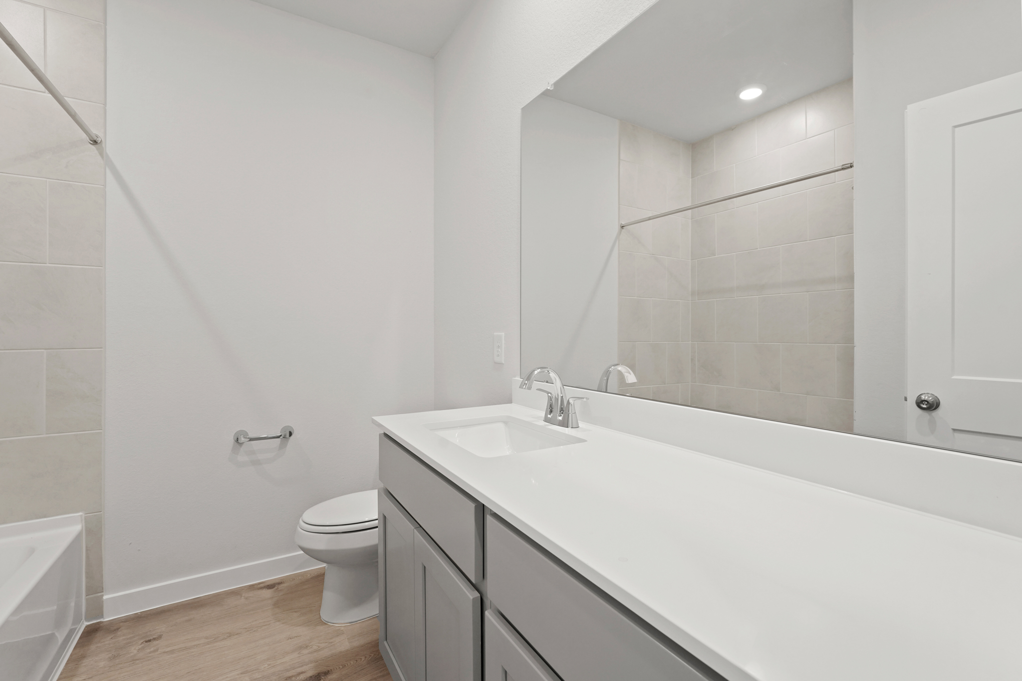 A bathroom with a tub sink and toilet.