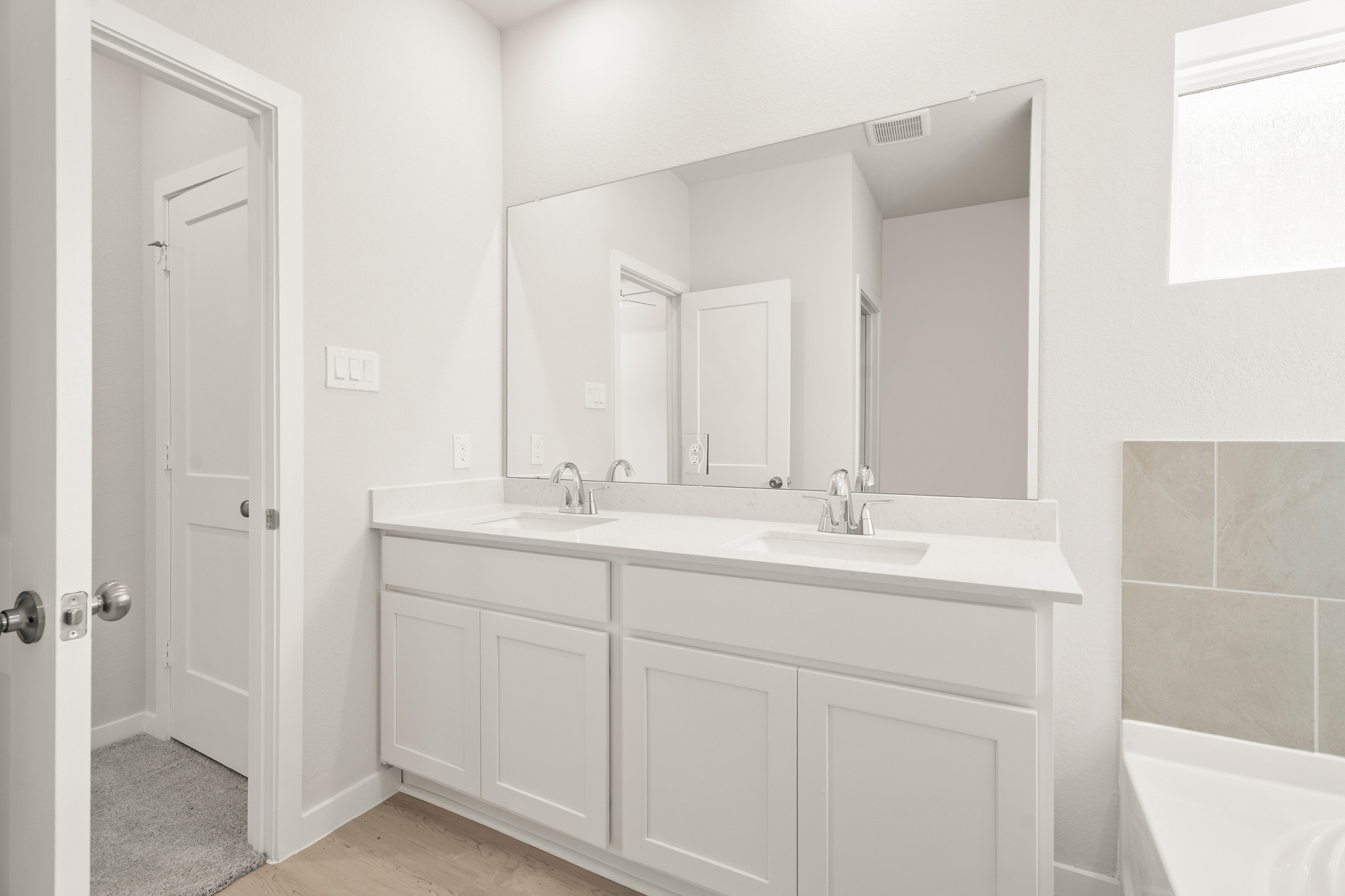 A bathroom with a sink and a tub.