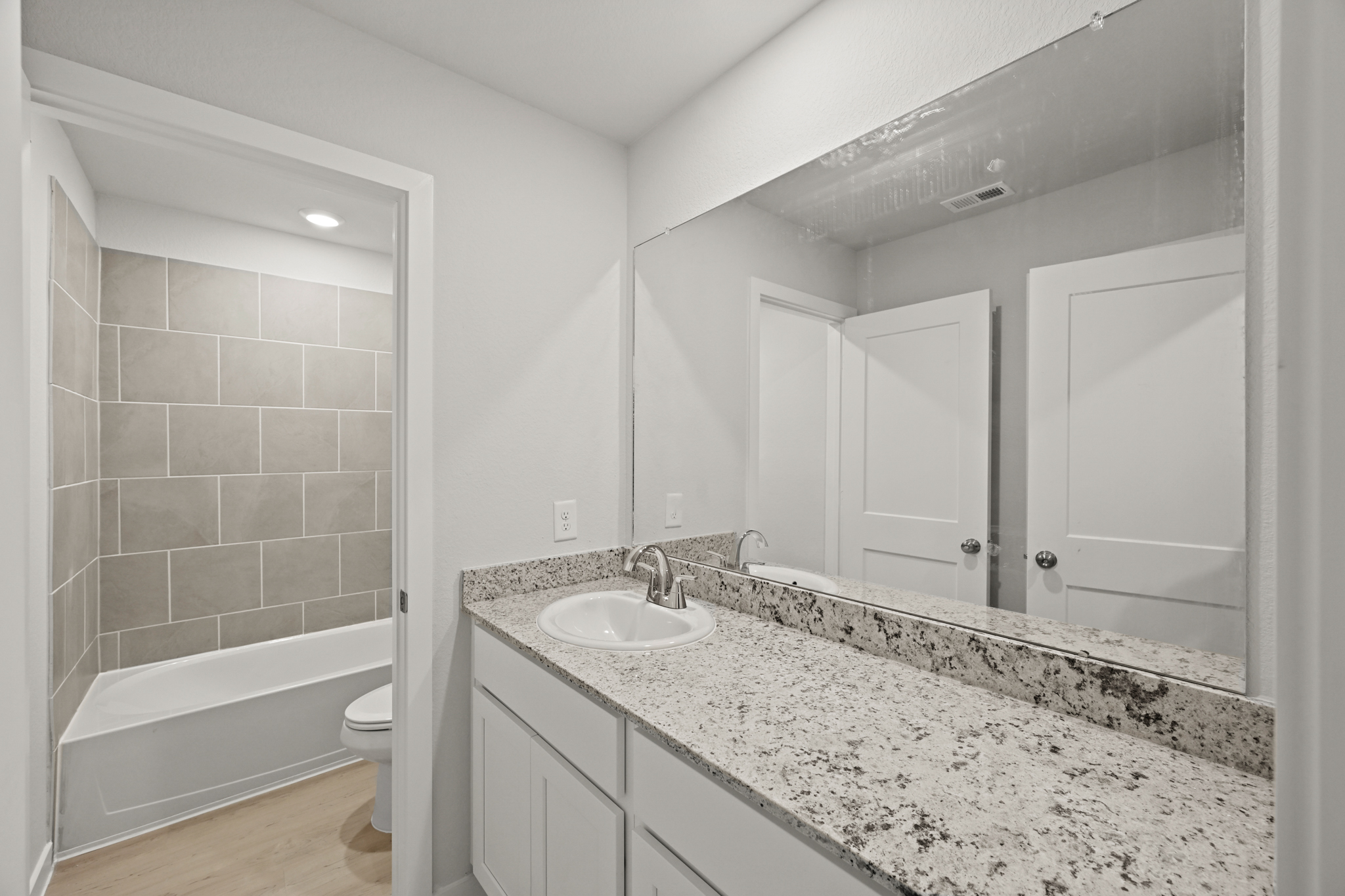 A bathroom with a marble countertop.