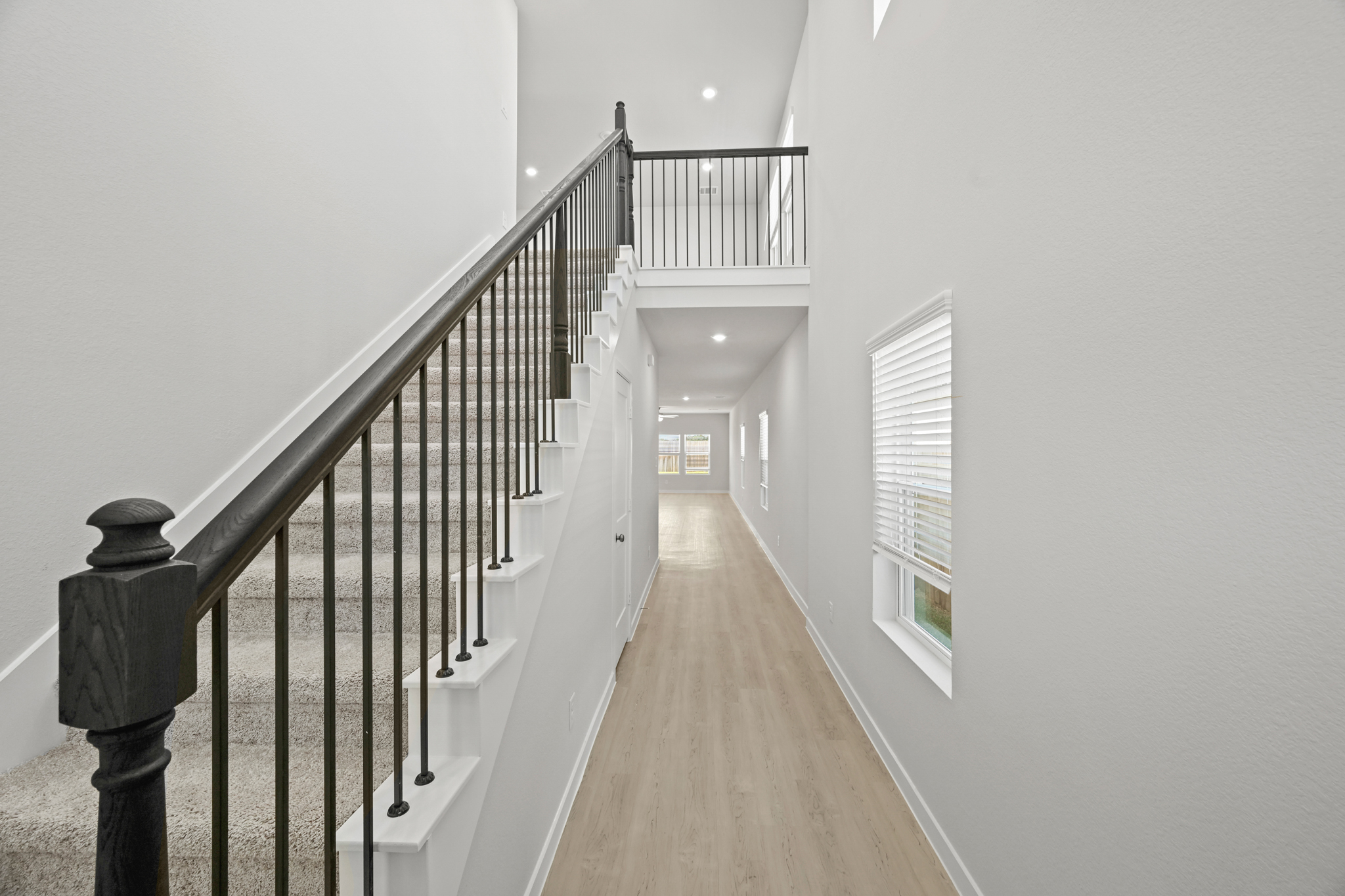 A long hallway with white walls.