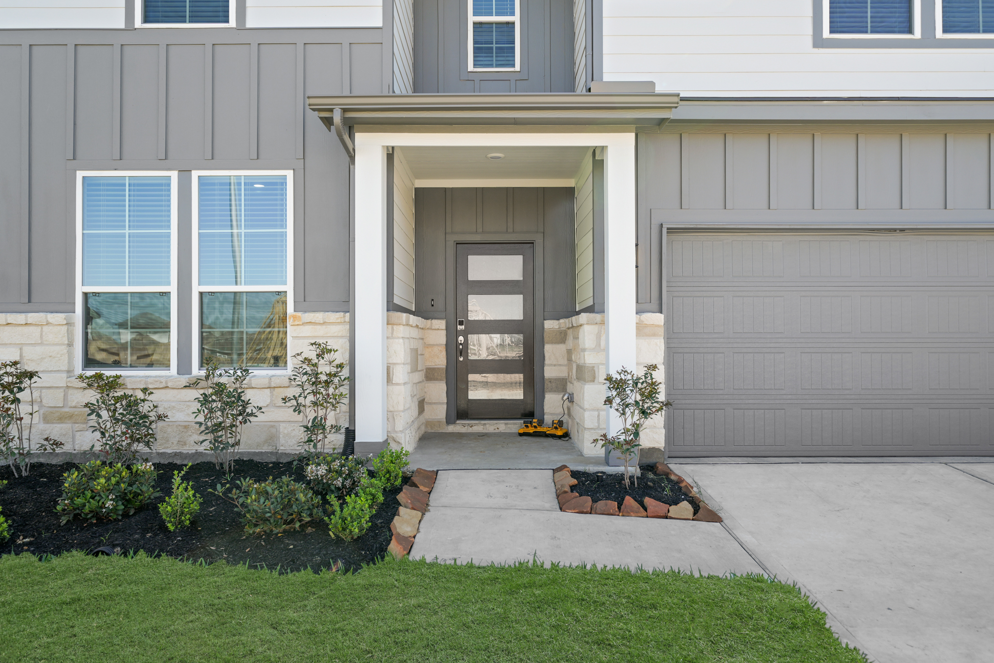 A house with a garage and a door.