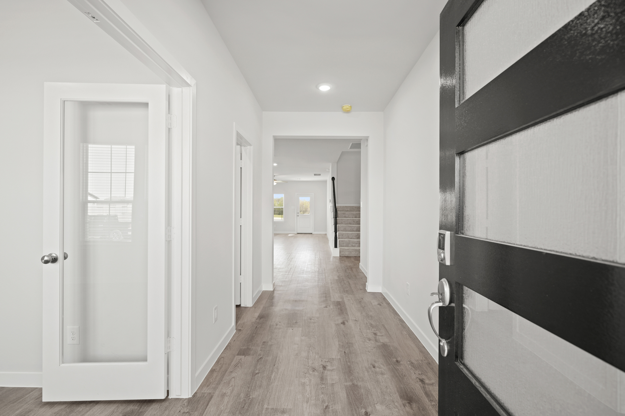 A hallway with white doors.