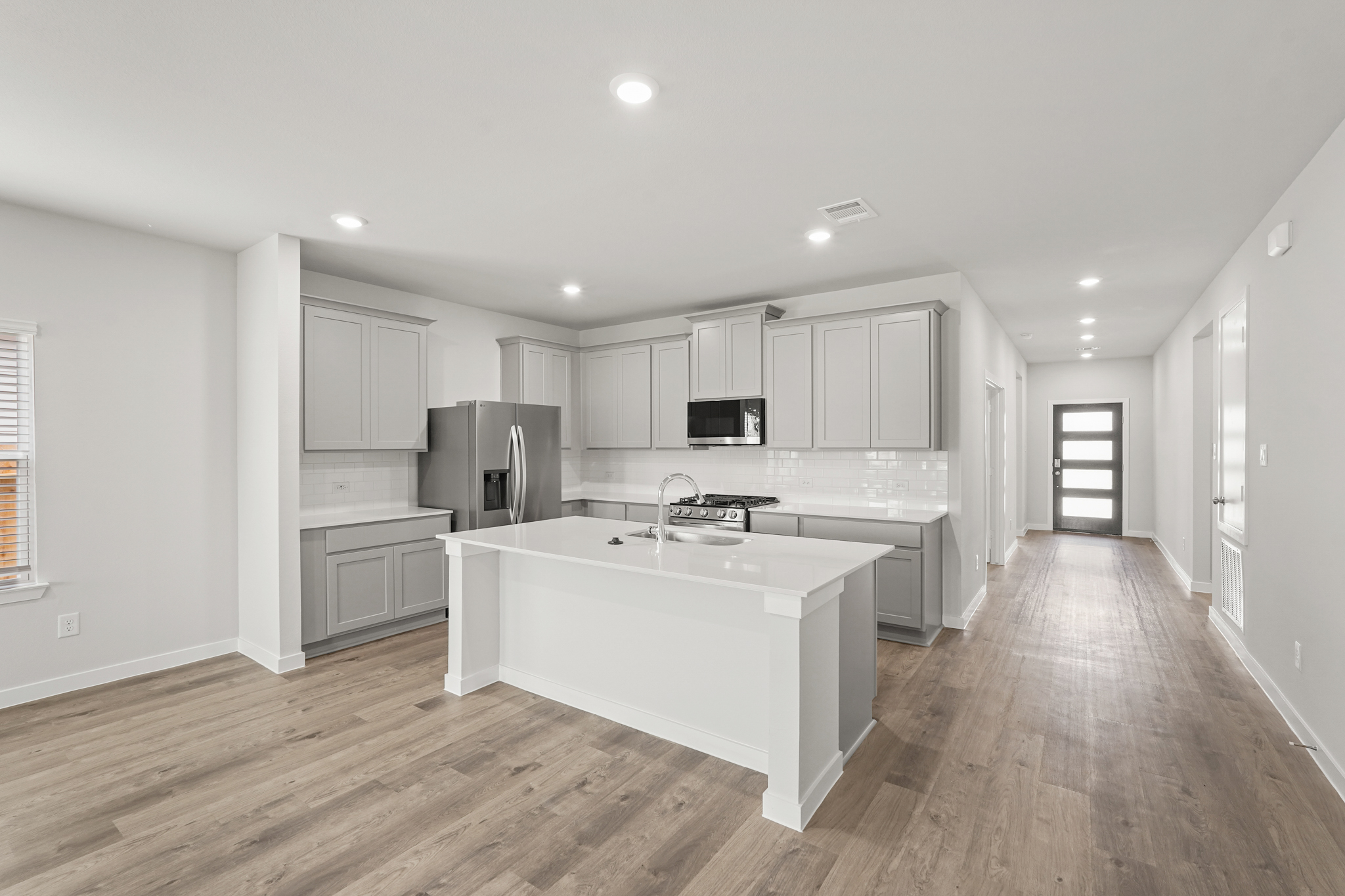 A kitchen with white cabinets.
