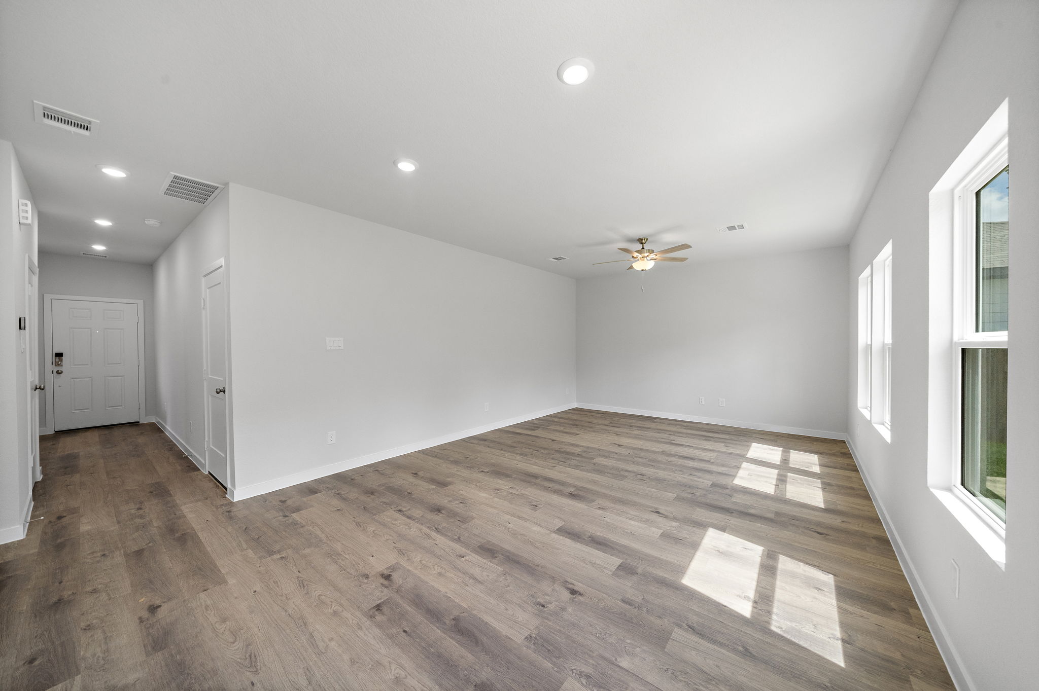 A room with a wood floor and white walls.