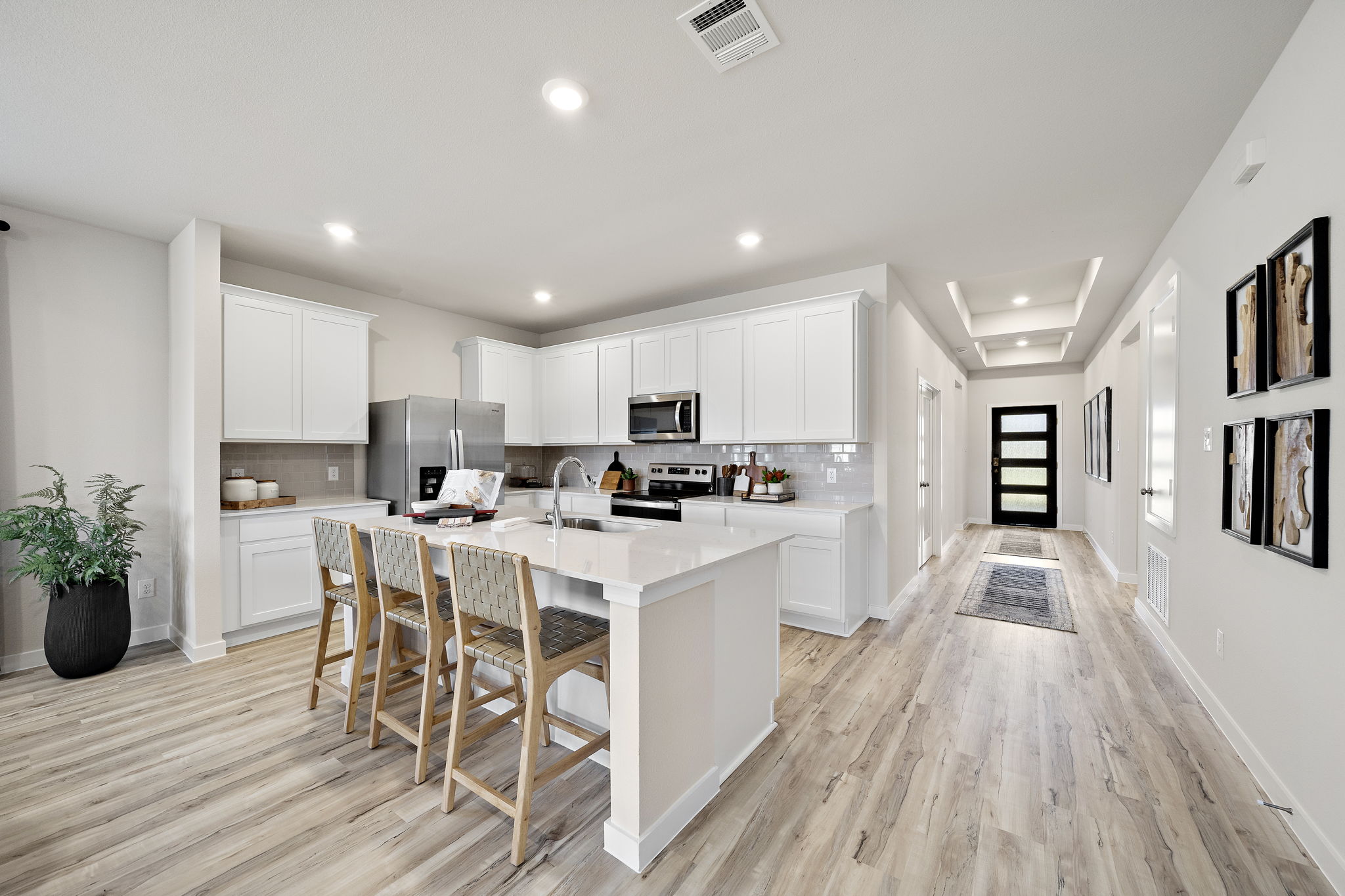 A kitchen with white cabinets.