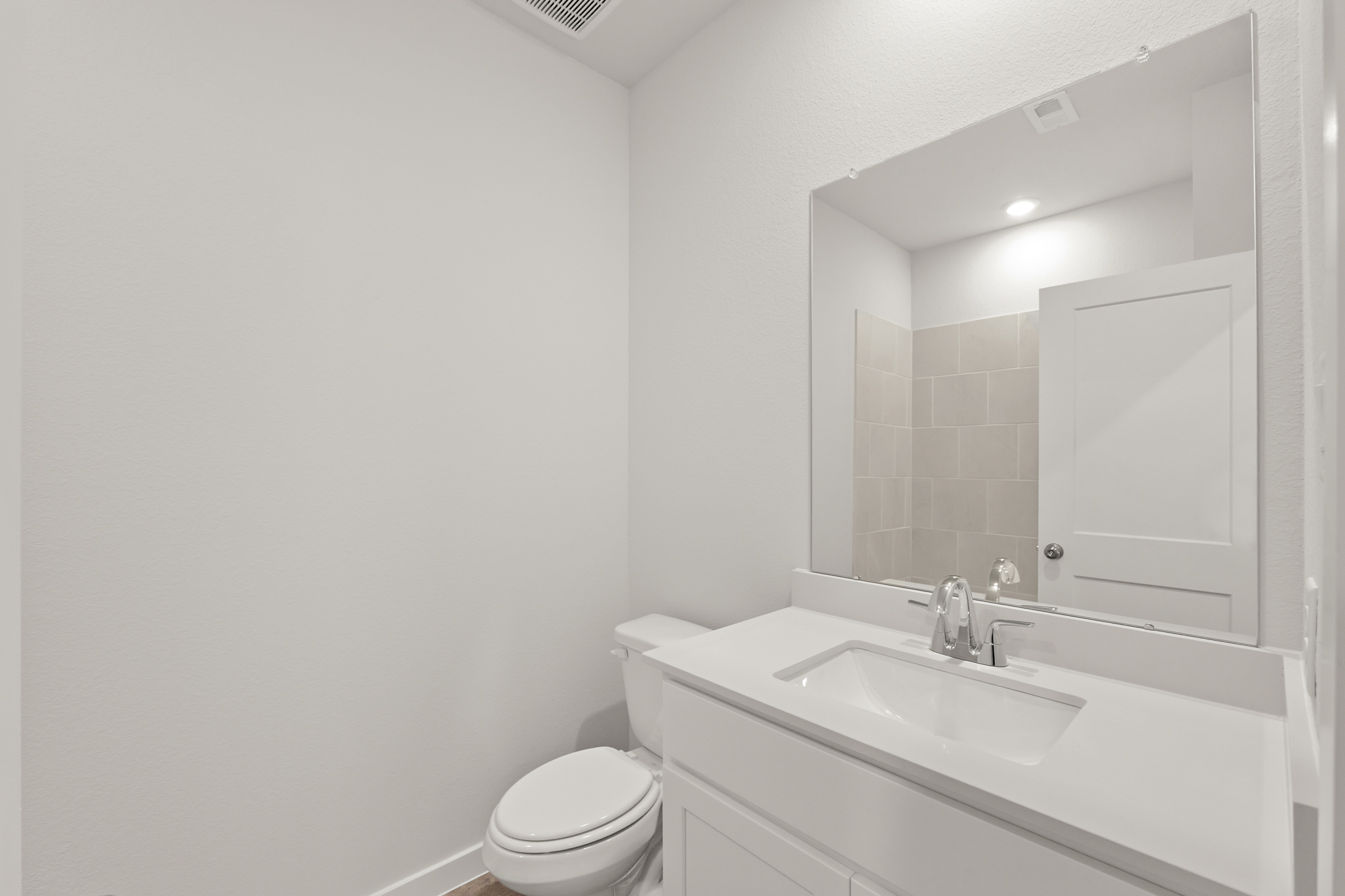 A bathroom with a sink and a toilet.