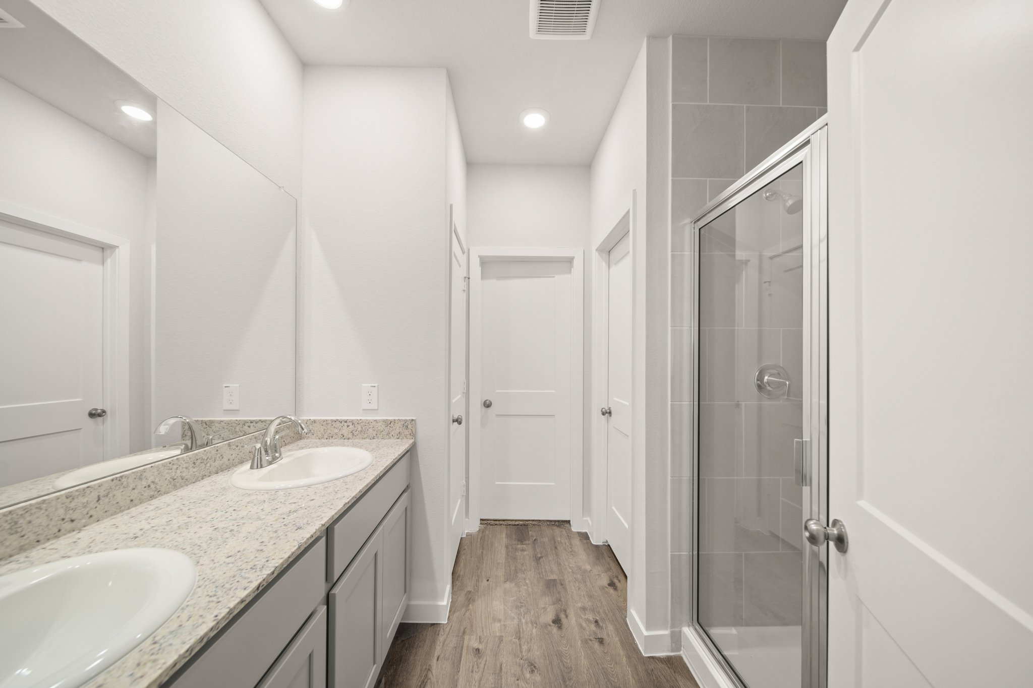 A bathroom with a sink and a shower.