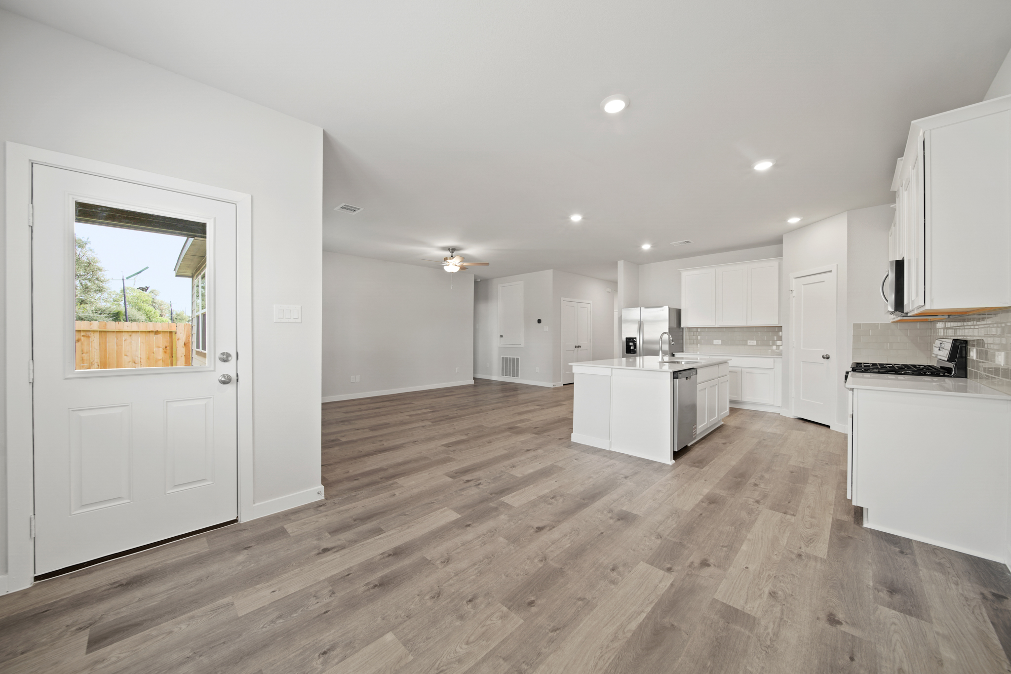 A kitchen with white cabinets.