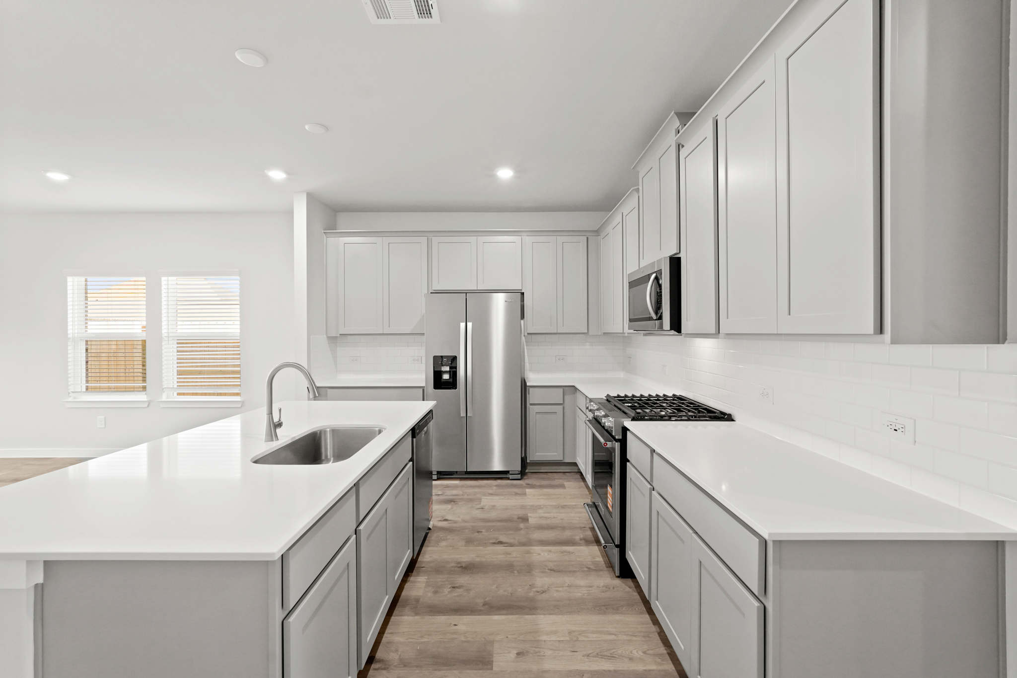 A kitchen with white cabinets.