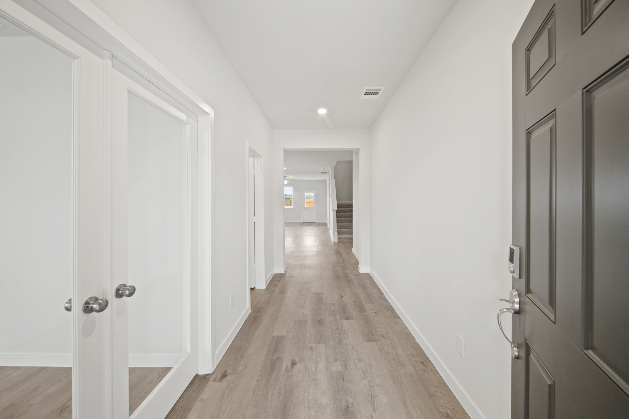 A hallway with white doors.