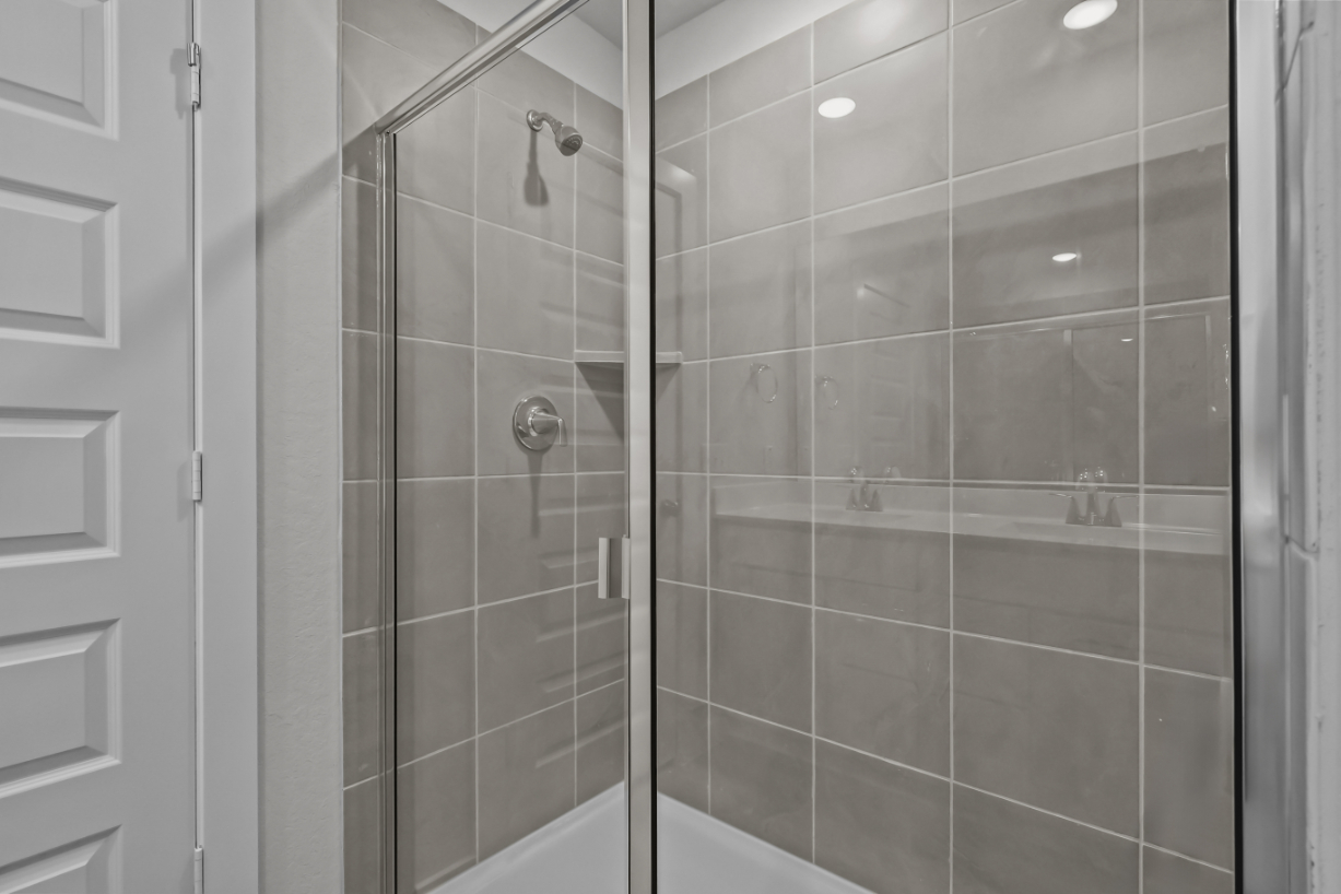 A shower with a glass door.