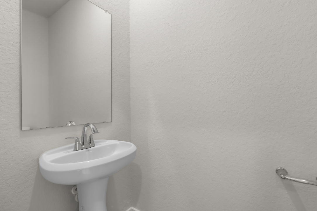 A bathroom with a mirror and sink.