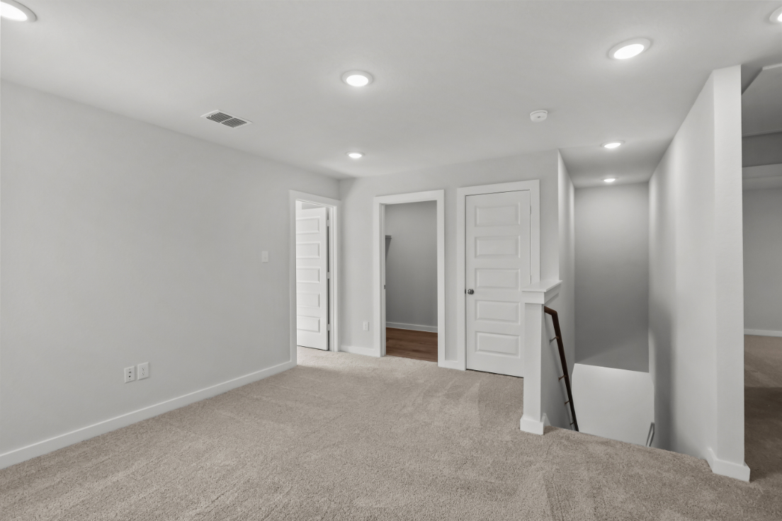 A hallway with white doors.