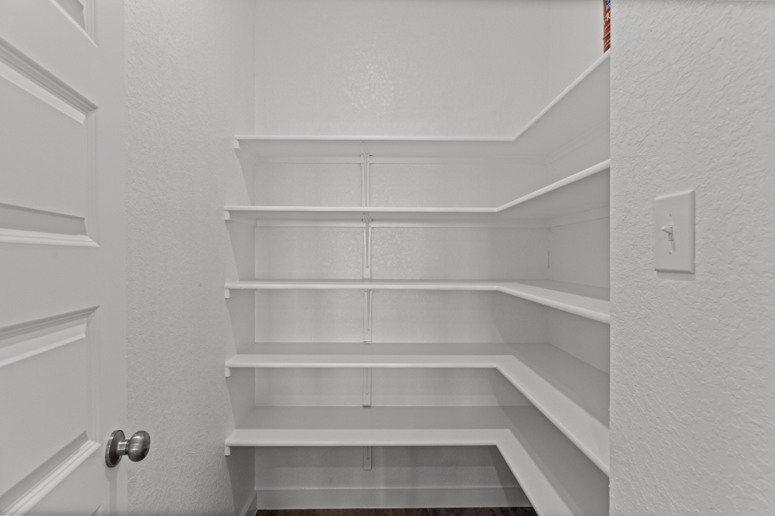 A white staircase with a light on the wall.