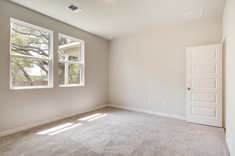 A room with a window and a door.