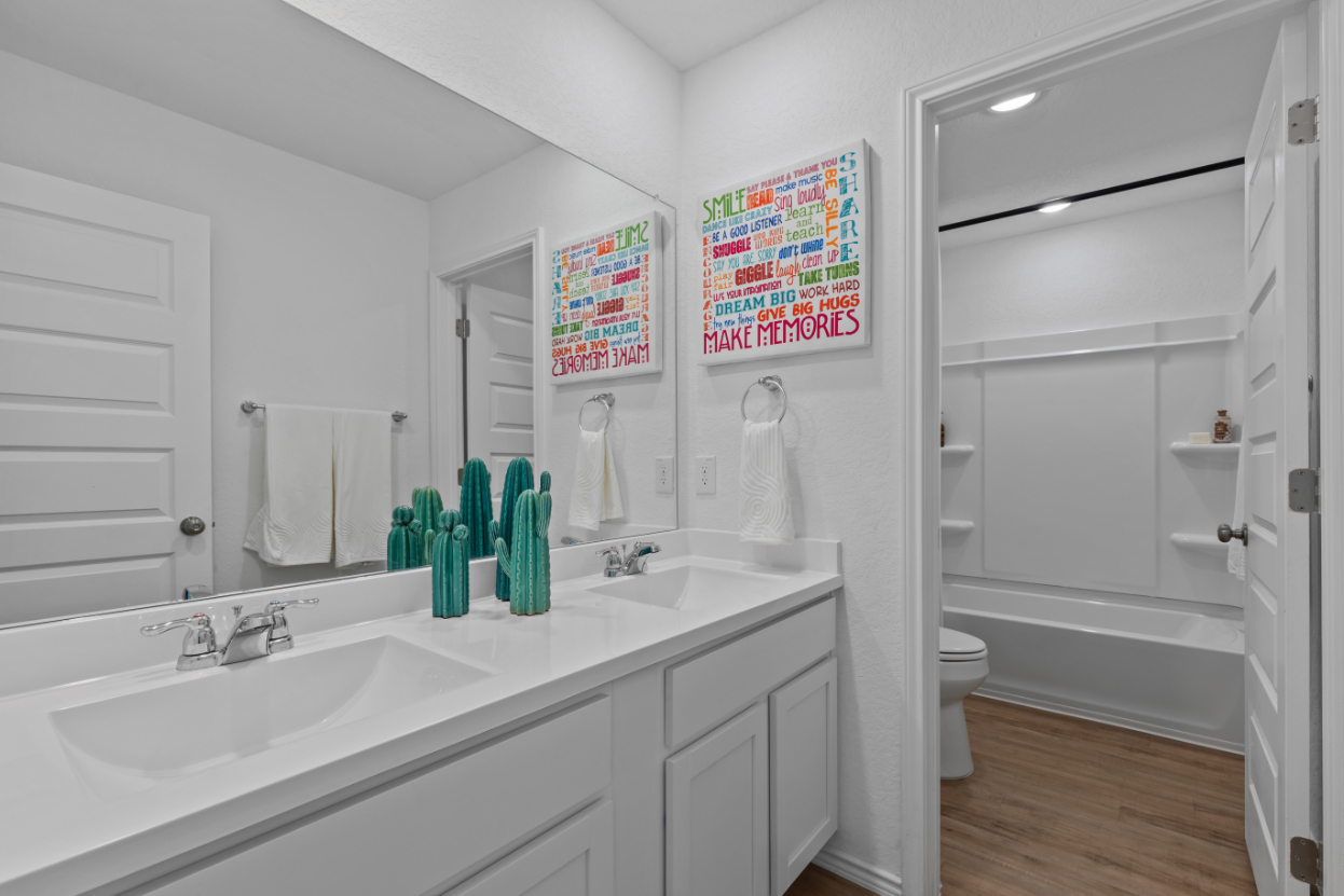 A bathroom with a sink toilet and a bathtub.