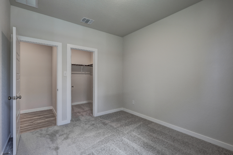 A room with a door and a mirror.