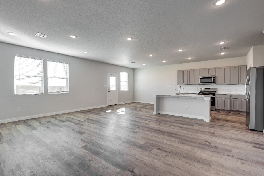 A large kitchen with wooden floors.