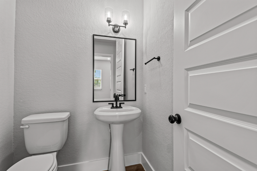 A bathroom with a sink and toilet.