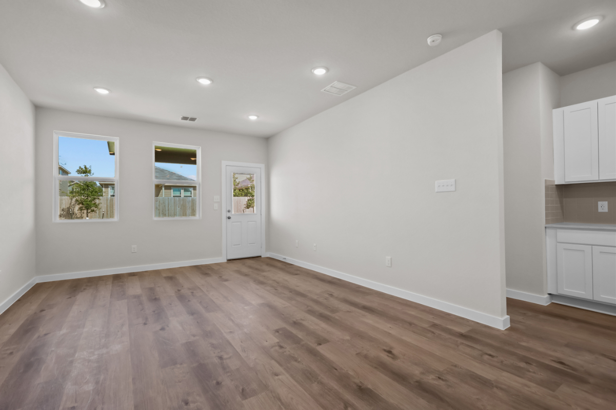 A room with white walls and a wood floor.