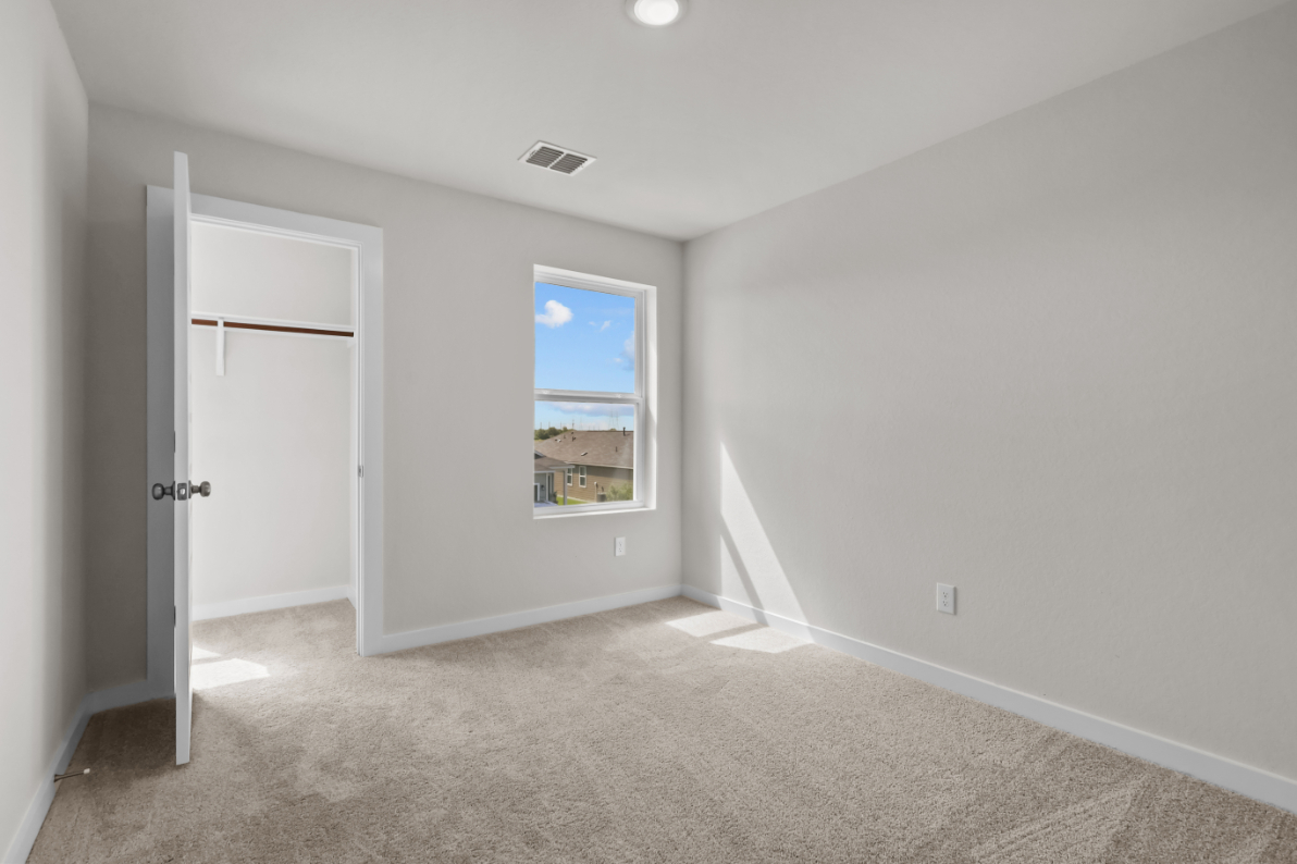 A room with a window and a door.
