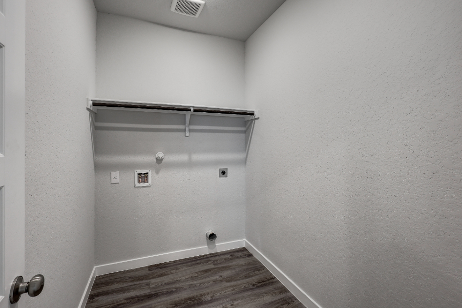 A room with a wood floor and a metal railing.